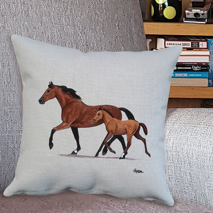 Mare & Foal Design on a throw pillow on a comfy chair.
