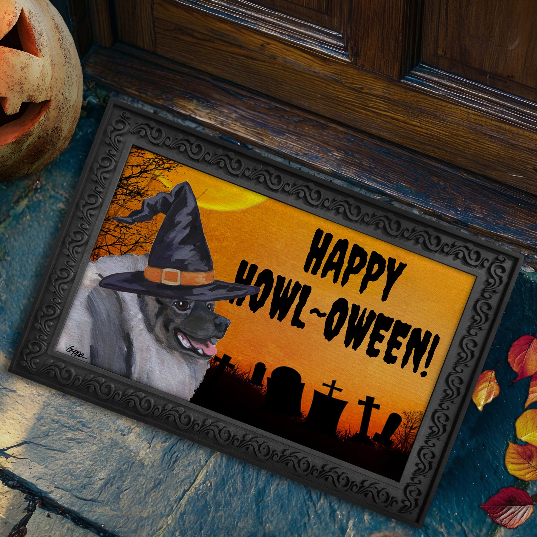 Halloween-themed doormat with a Keeshond wearing a witch hat and 'Happy Howl-Oween!' text, placed on a stone surface.