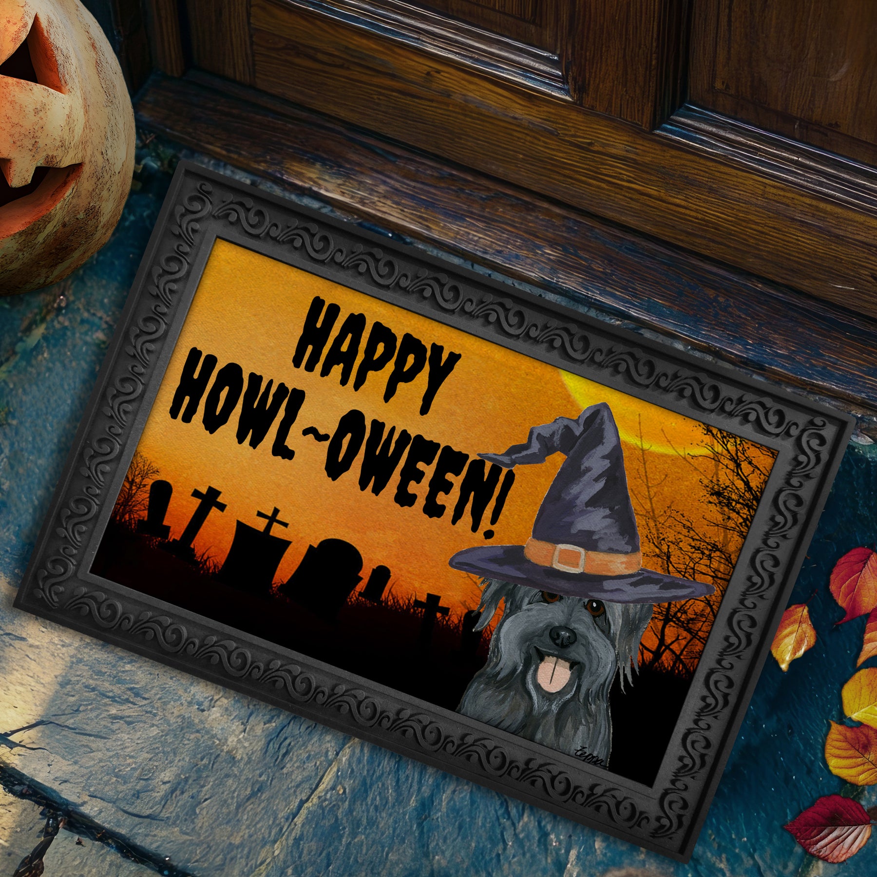 Halloween-themed doormat with a Pyrenean Shepherd wearing a witch hat and 'Happy Howl-Oween!' text.