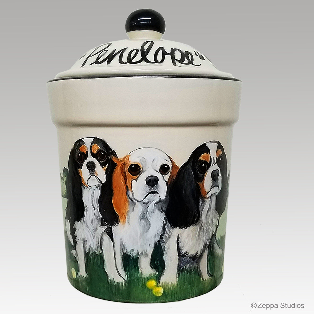 Three Cavalier King Charles Spaniels hand painted on a ceramic treat jar by Zeppa Studios.