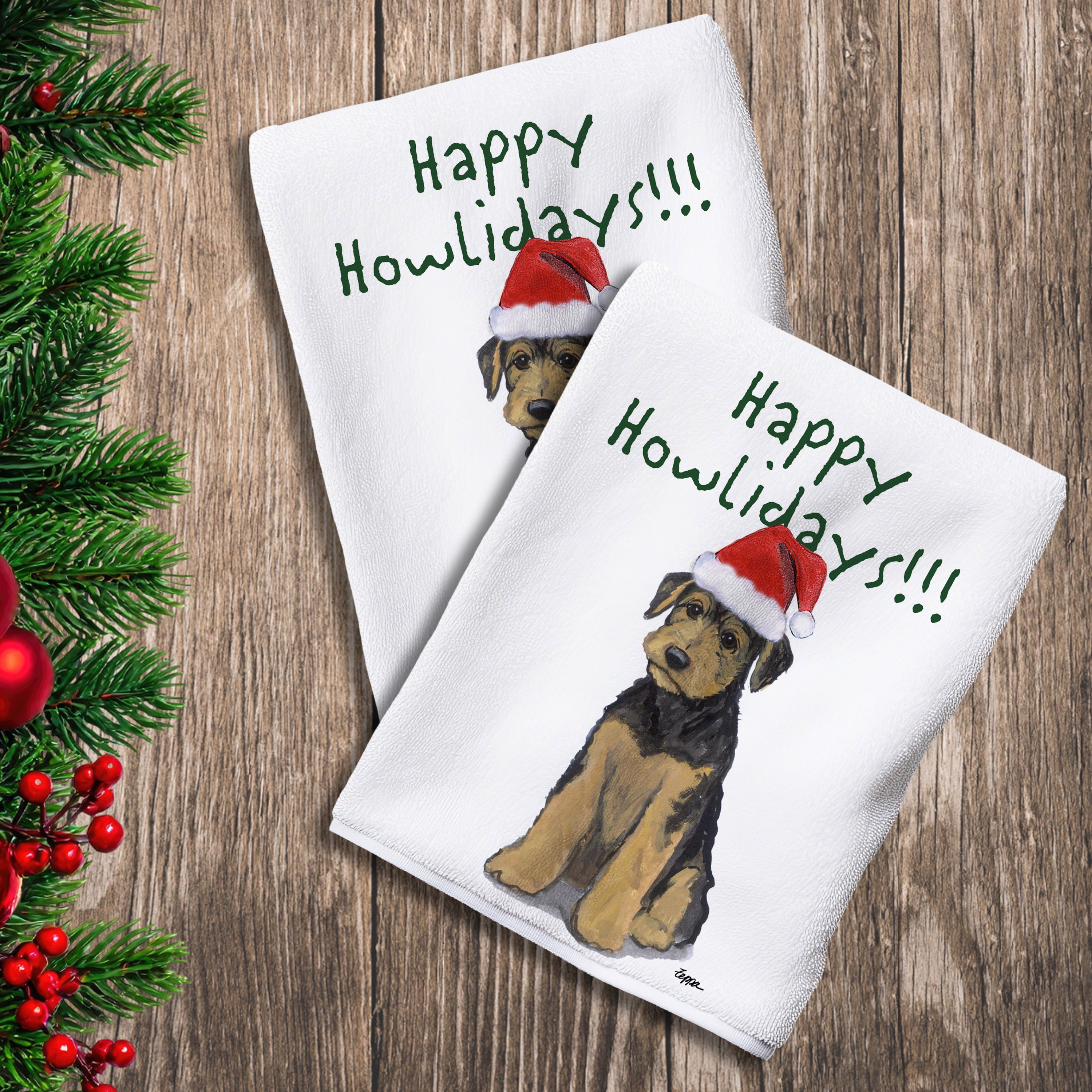 2 Kitchen Towels with an Airedale Puppy in a Santa Hat and Happy Howlidays text.