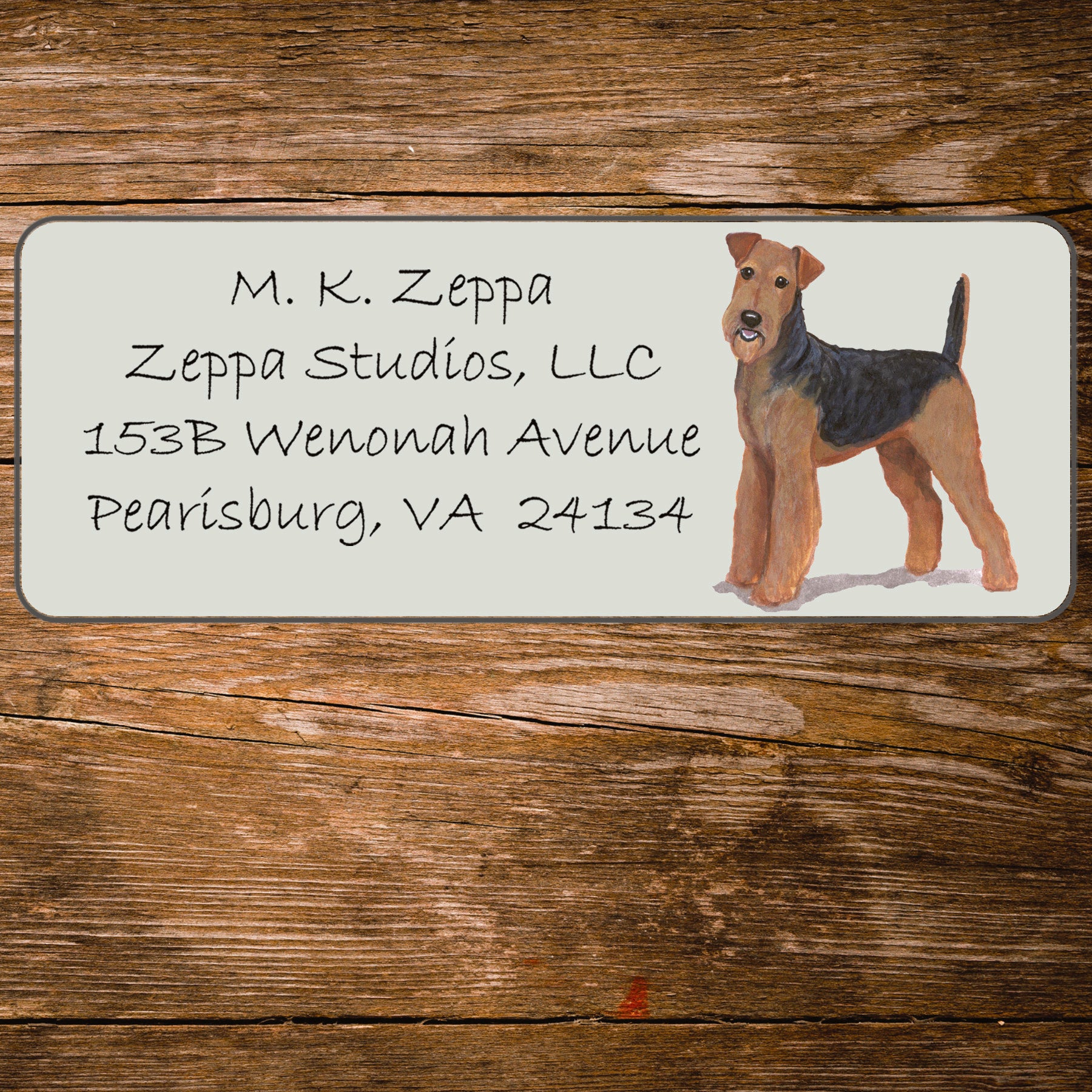 Address label with an Airedale Terrier illustration on a wooden surface