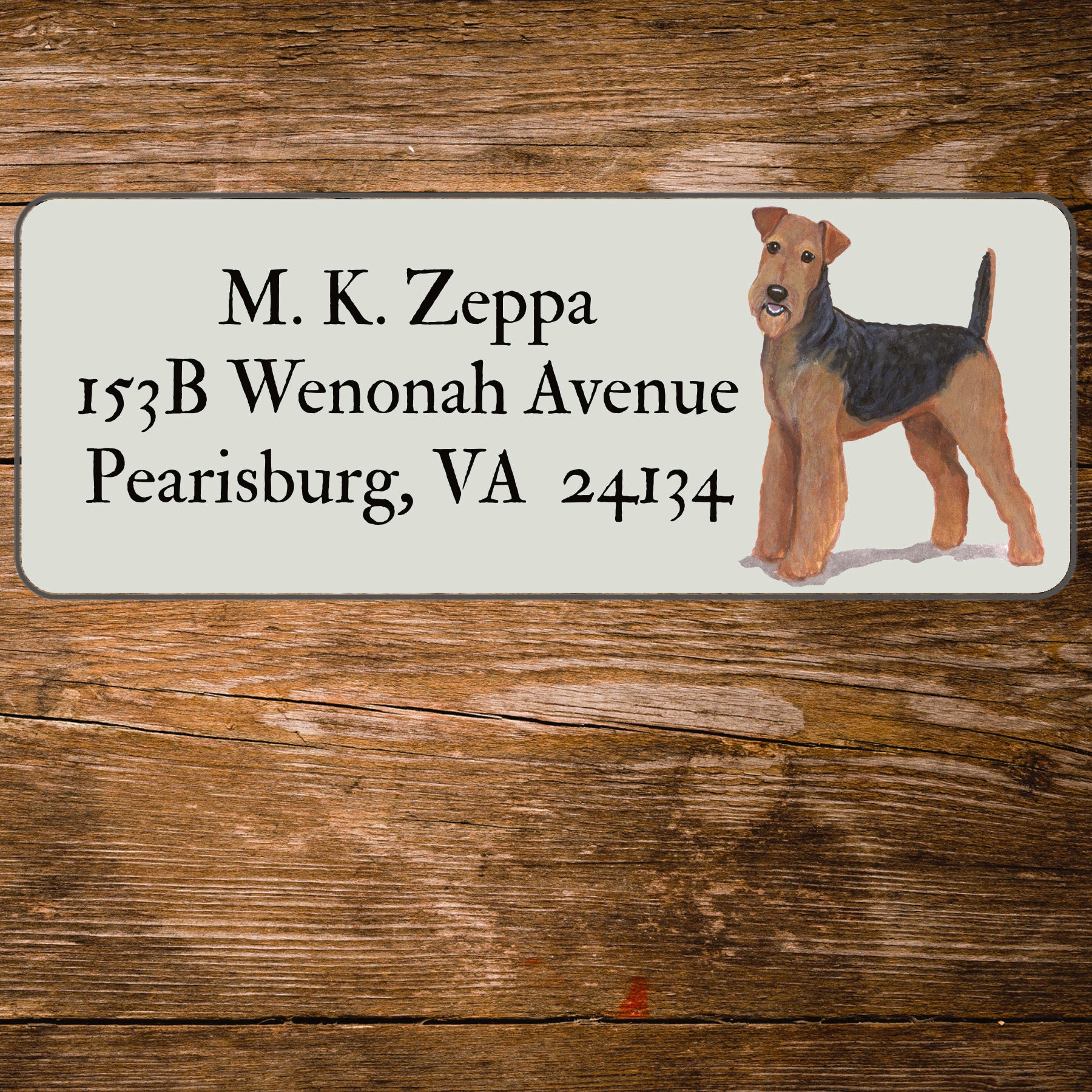 Address label with an Airedale Terrier illustration on a wooden surface