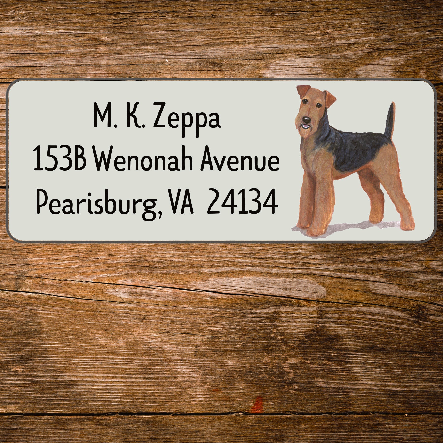 Address label with an Airedale Terrier illustration on a wooden surface