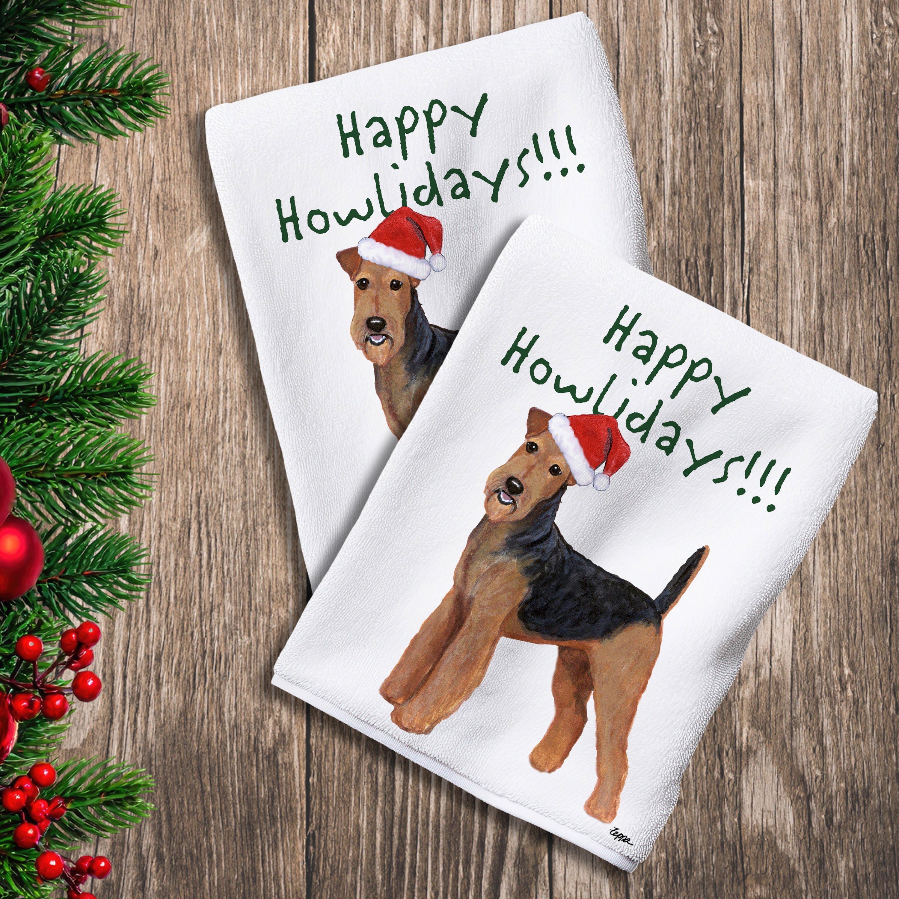2 Kitchen Towels with an Airedale Terrier in a Santa Hat and Happy Howlidays text.