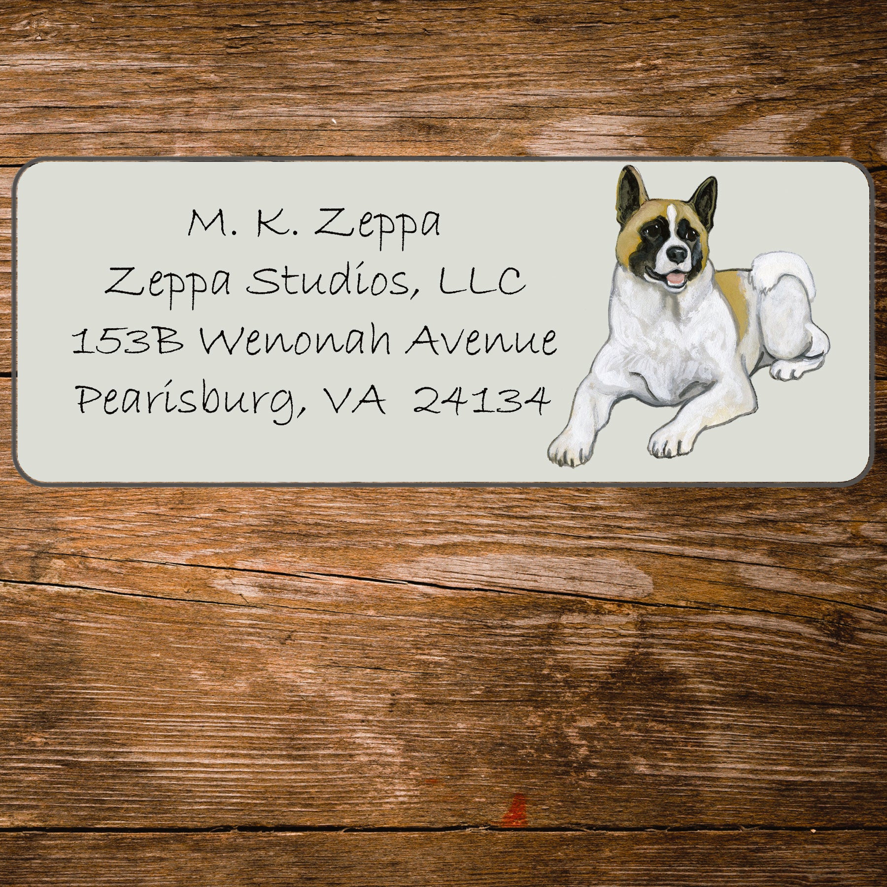 Address label with an Akita illustration on a wooden surface