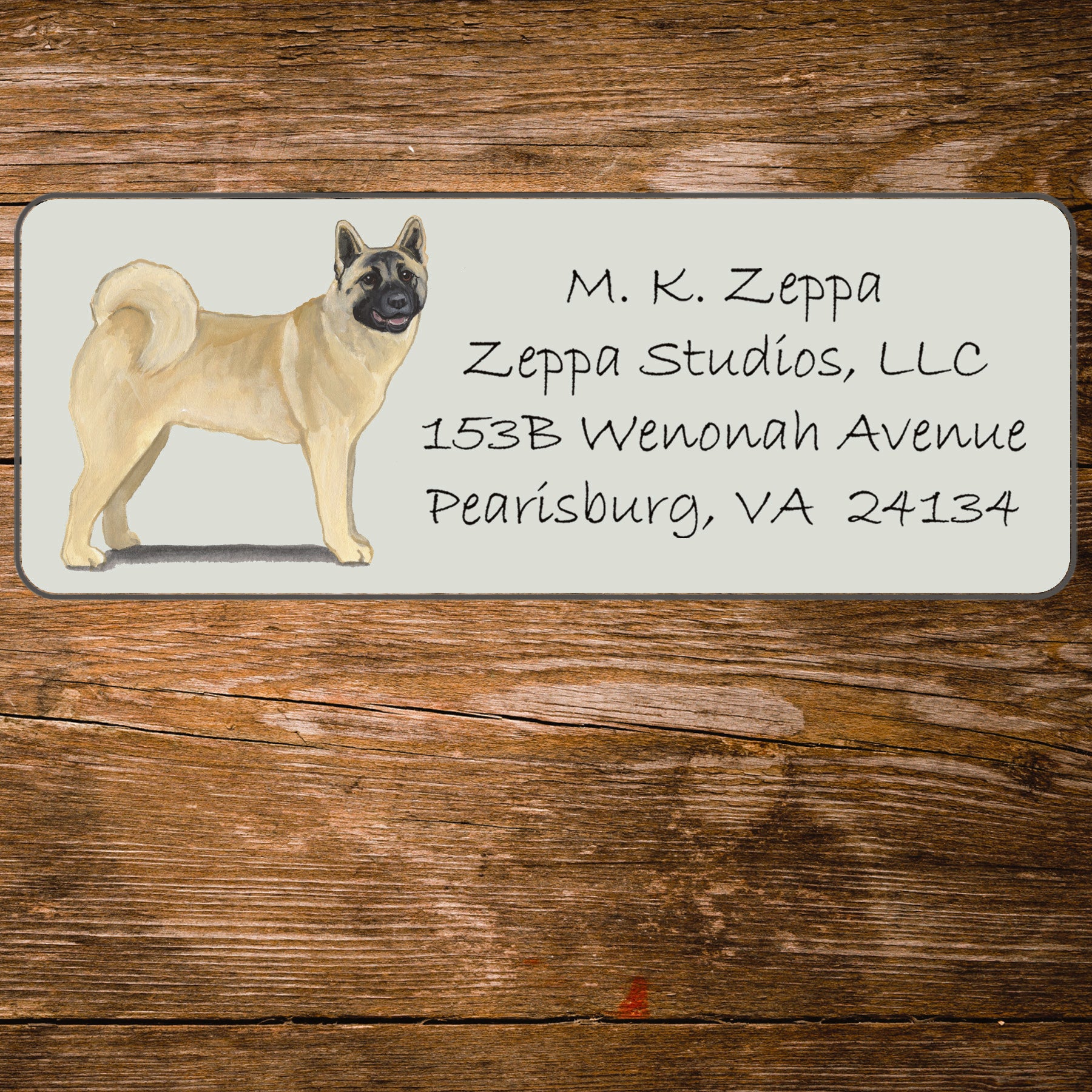 Address label with an Akita illustration on a wooden surface