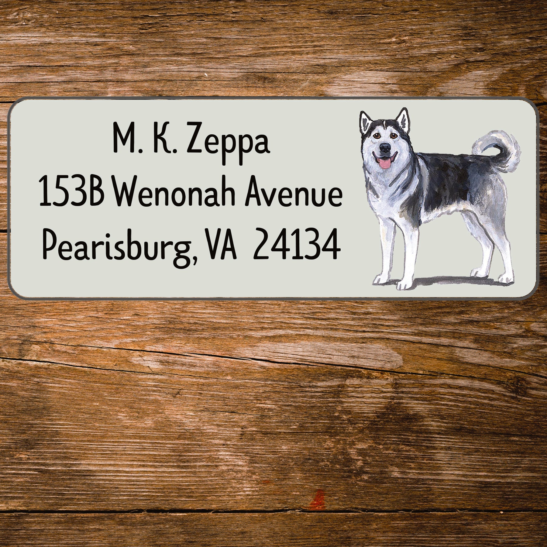 Address label with an Alaskan Malamute illustration on a wooden surface