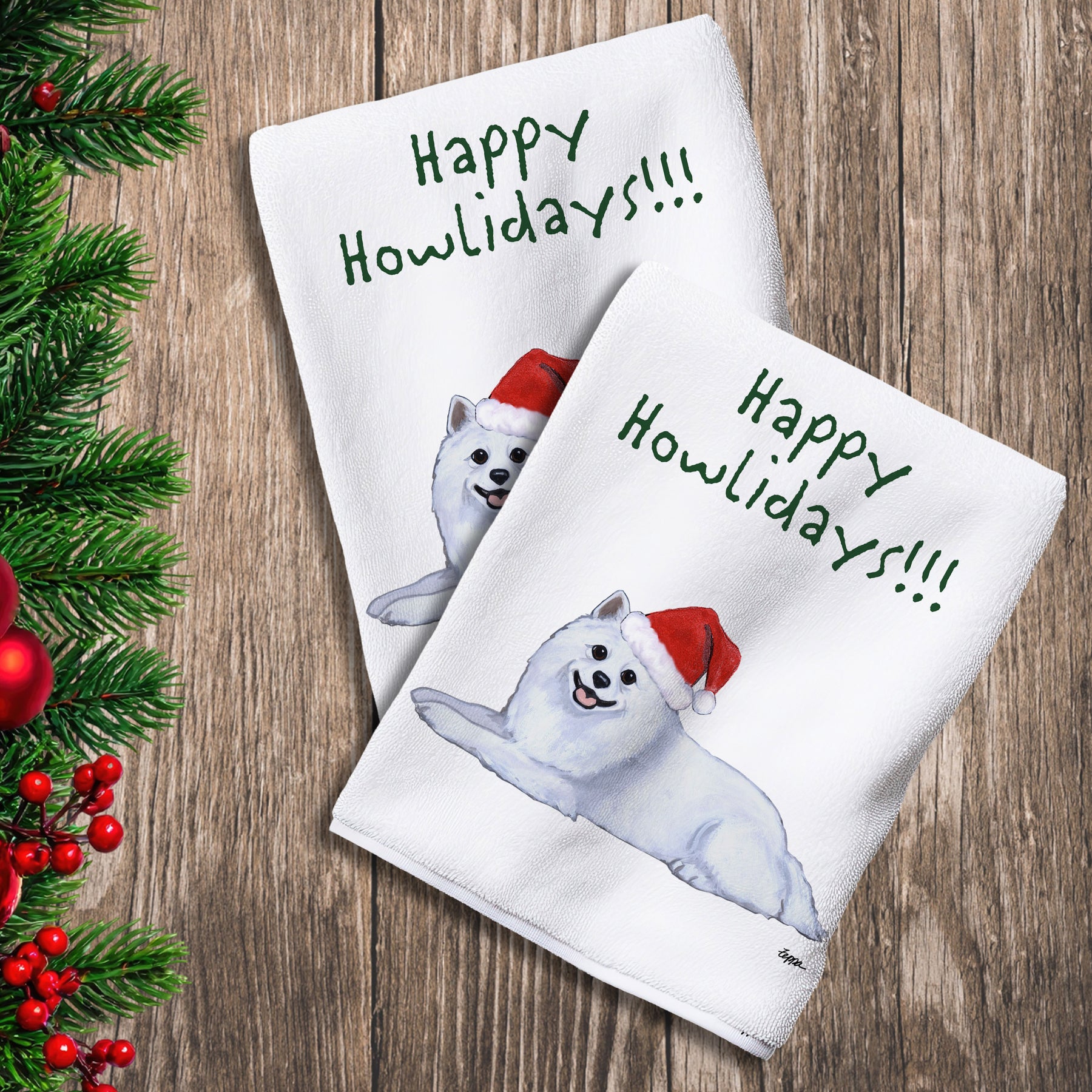 2 Kitchen Towels with an American Eskimo Dog in a Santa Hat and Happy Howlidays text. 