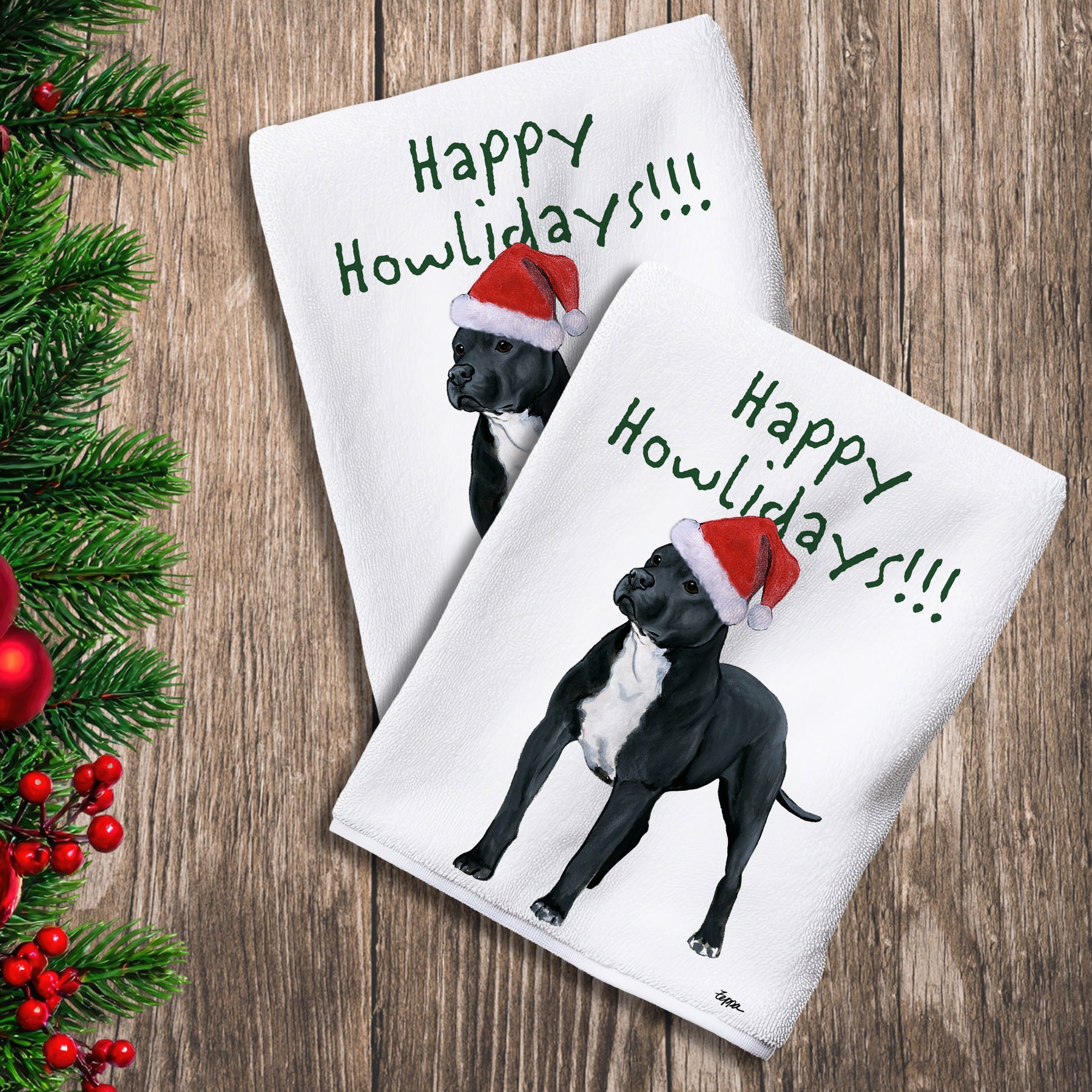 2 Kitchen Towels with a black Pit Bull in a Santa Hat and Happy Howlidays text.