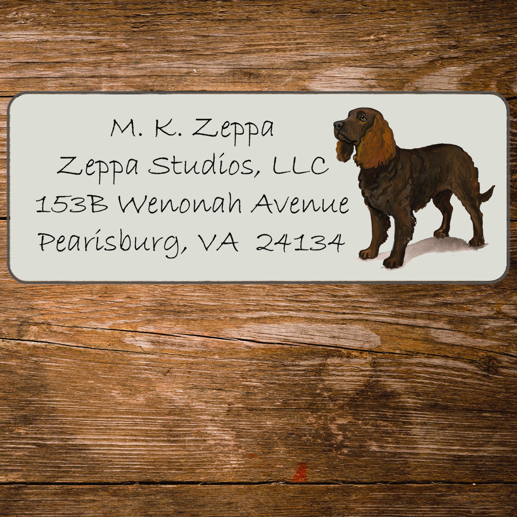 Return address label with an American Water Spaniel illustration on a wooden surface