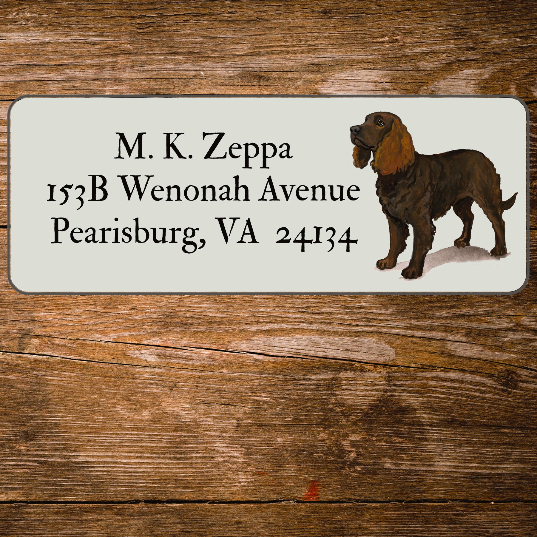 Return address label with an American Water Spaniel illustration on a wooden surface