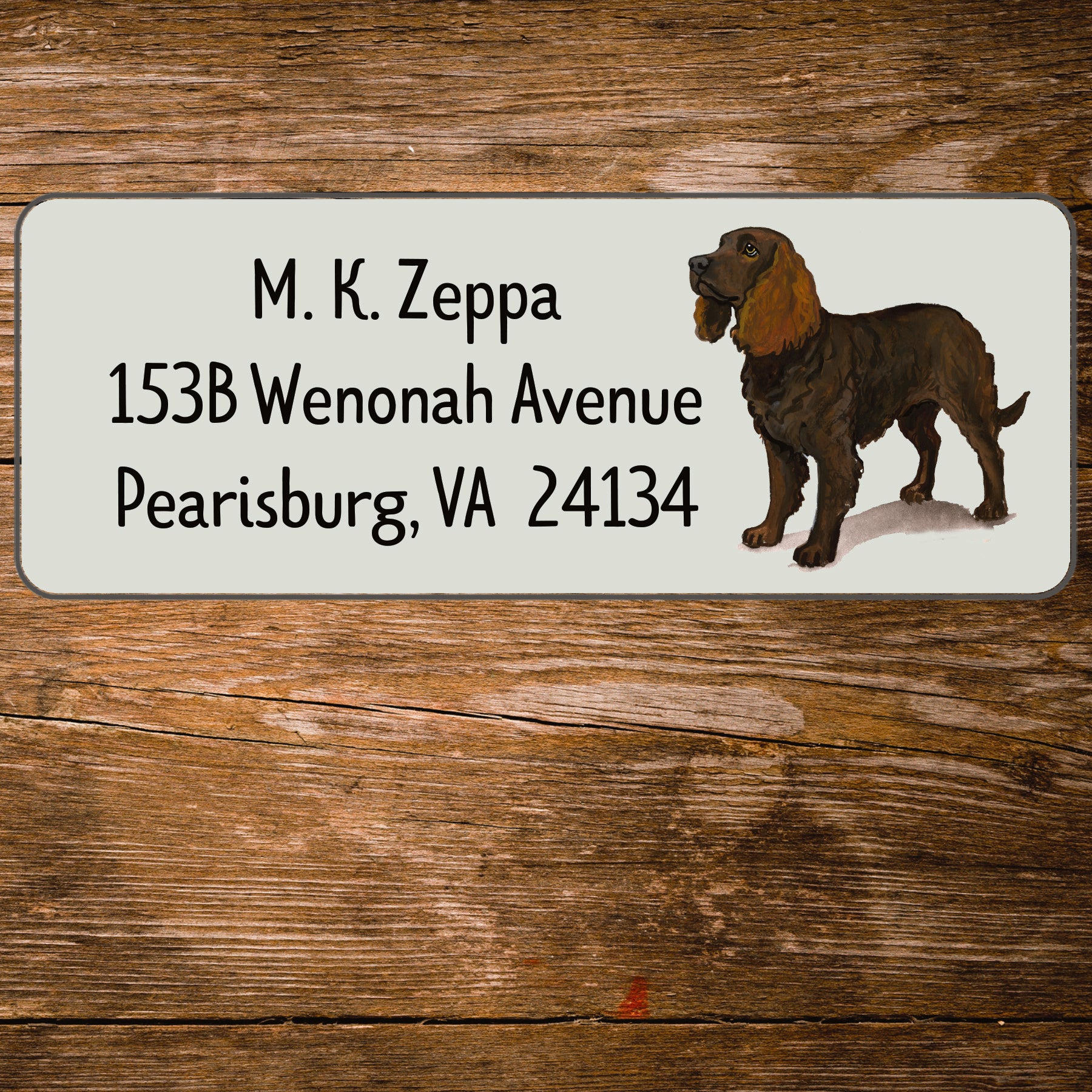 Return address label with an American Water Spaniel illustration on a wooden surface