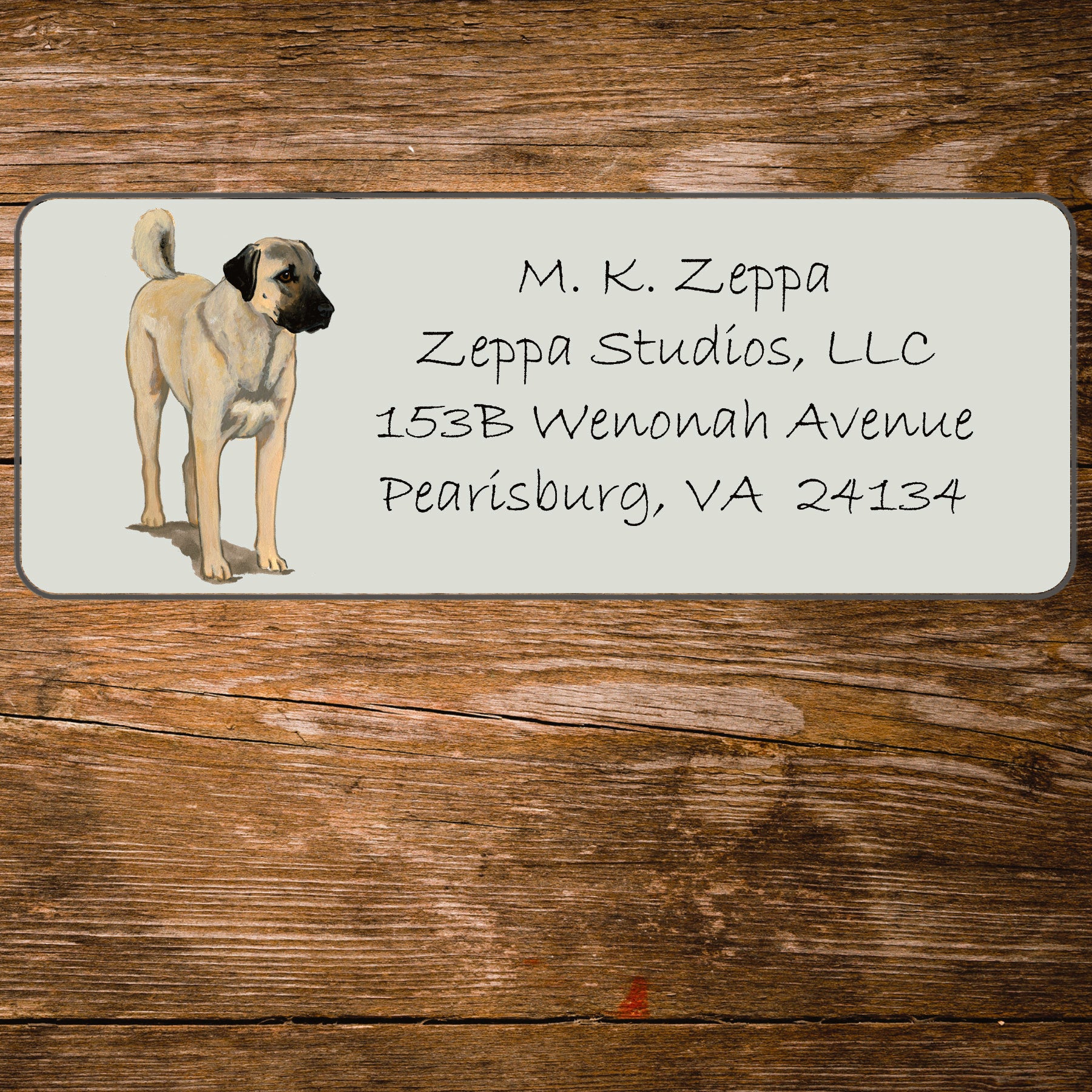 Return address label with an Anatolian Shepherd Dog illustration on a wooden surface