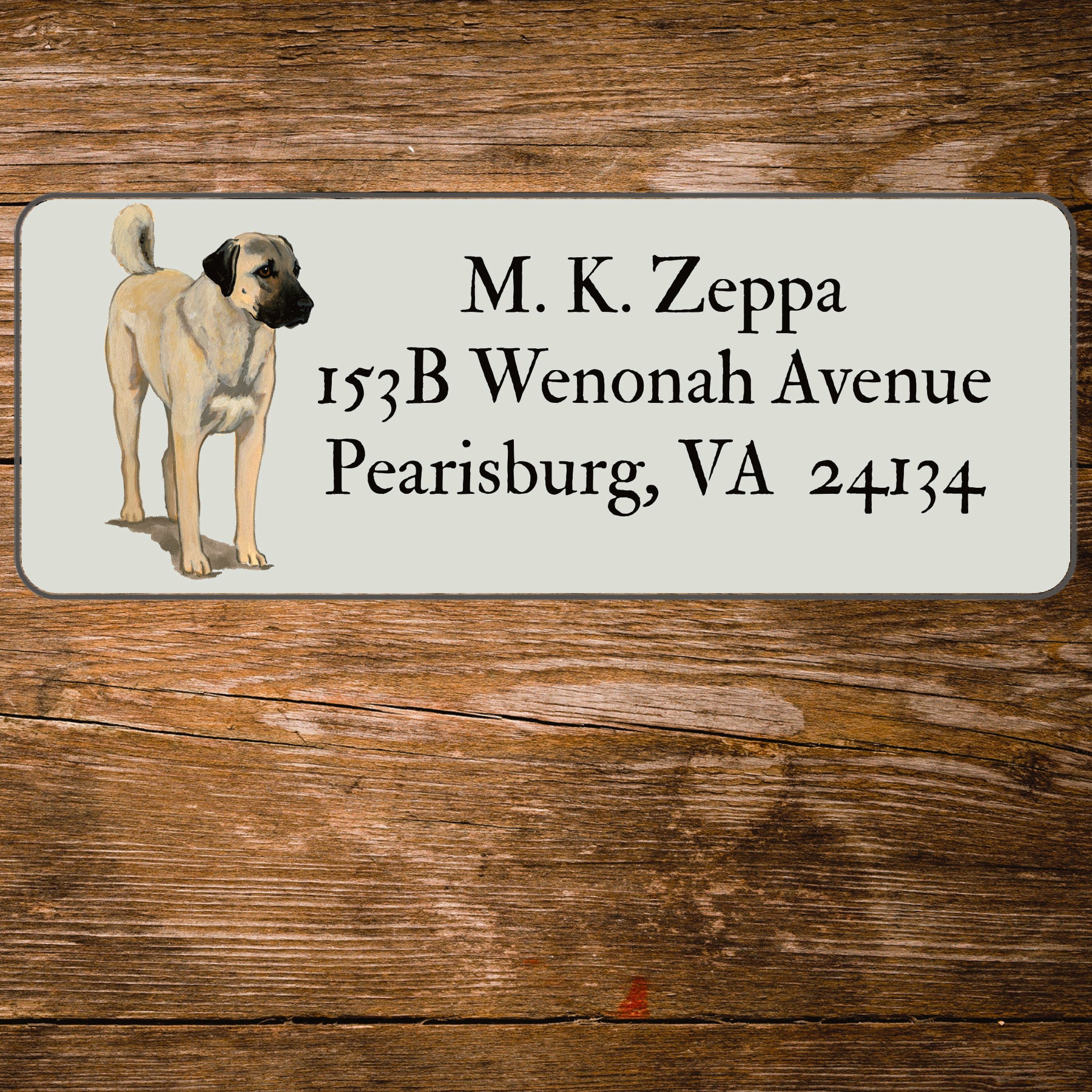 Return address label with an Anatolian Shepherd Dog illustration on a wooden surface