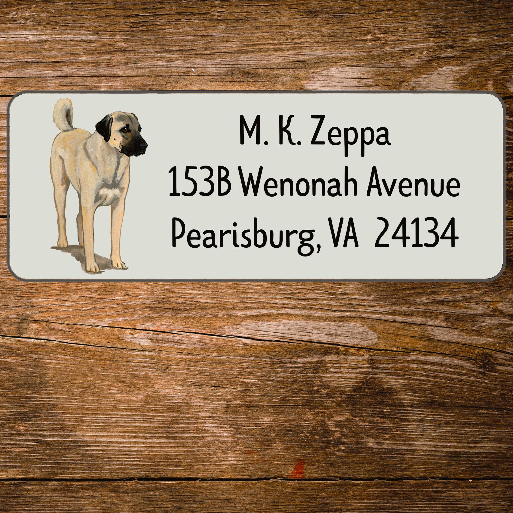 Return address label with an Anatolian Shepherd Dog illustration on a wooden surface