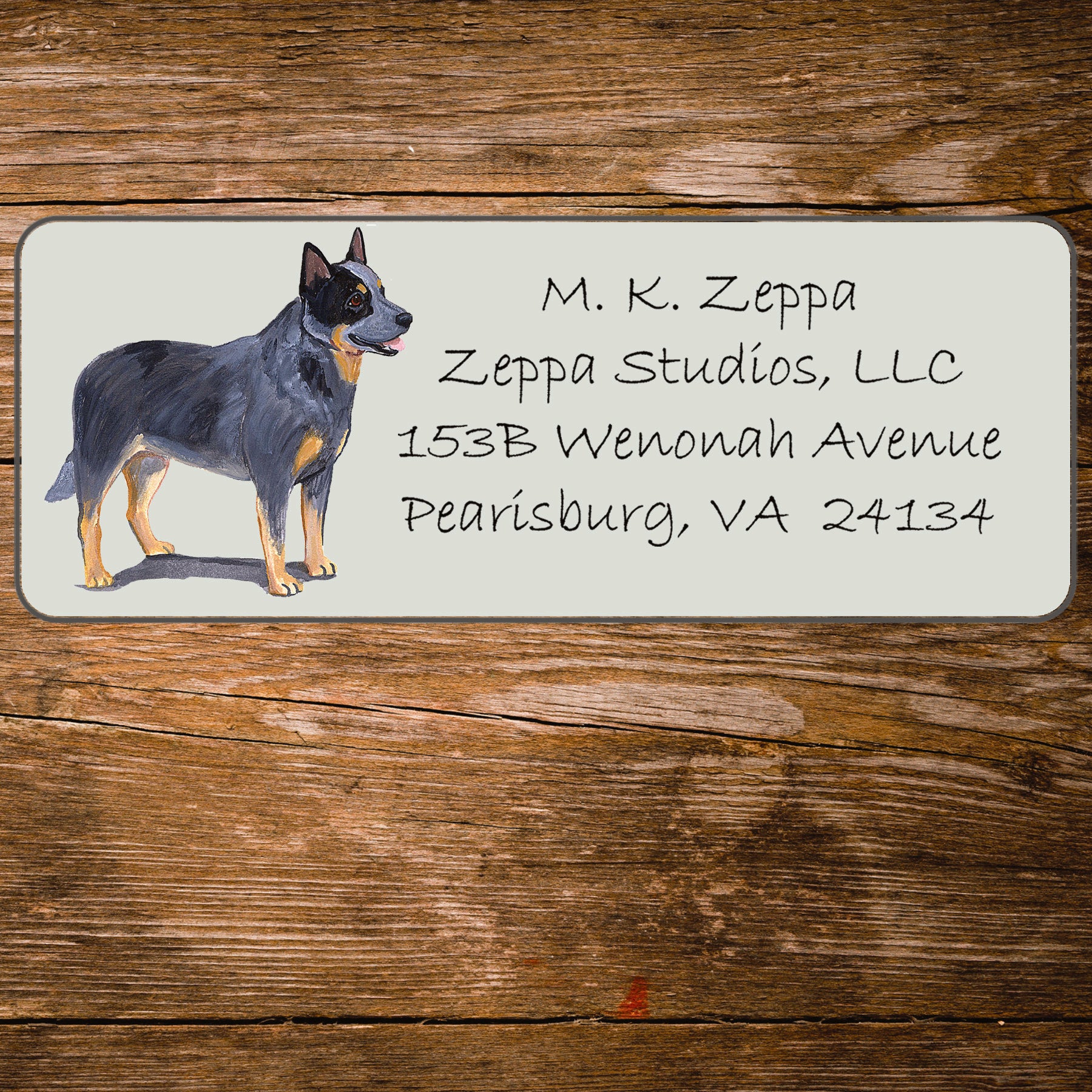 Return address label with an Australian Cattle Dog illustration on a wooden surface