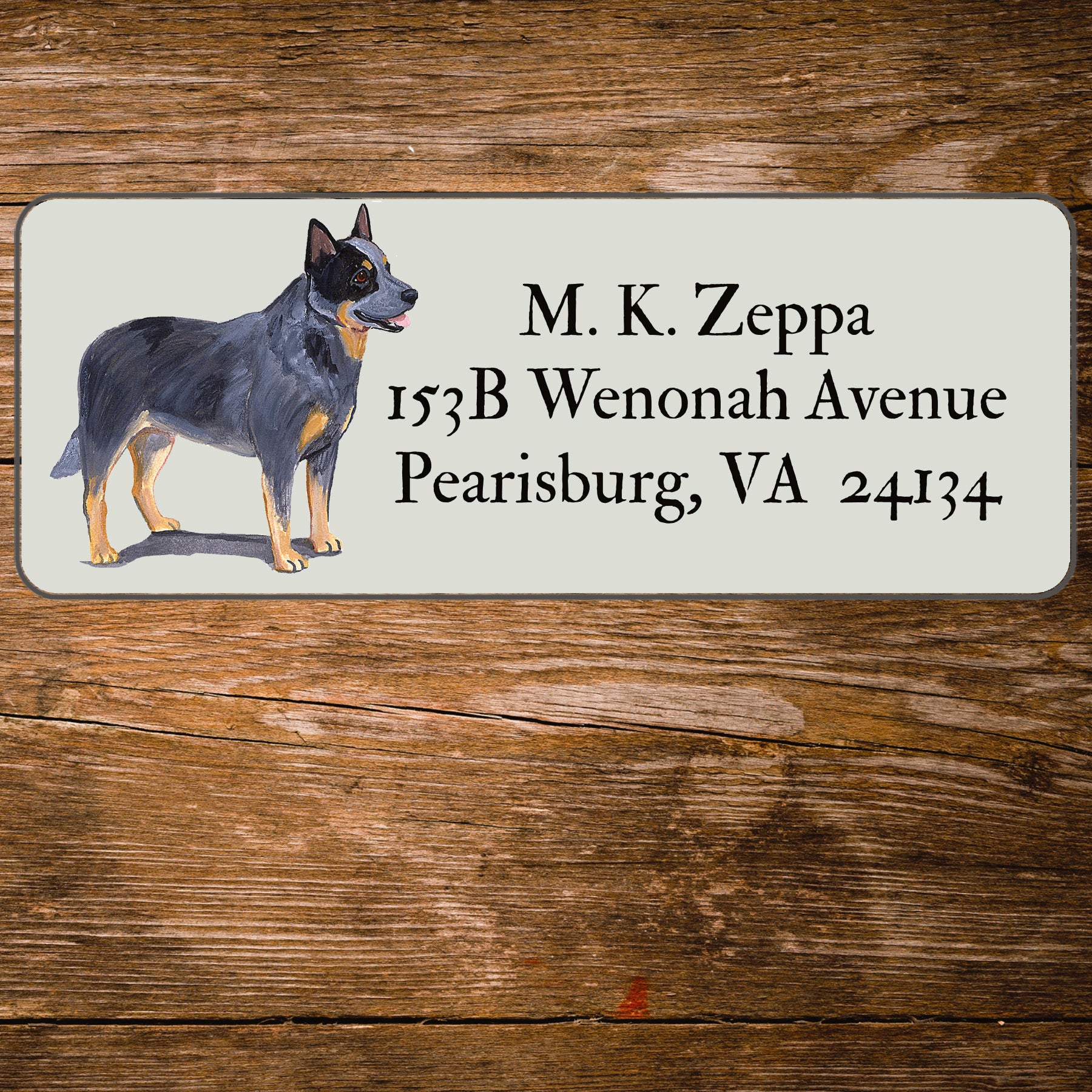 Return address label with an Australian Cattle Dog illustration on a wooden surface