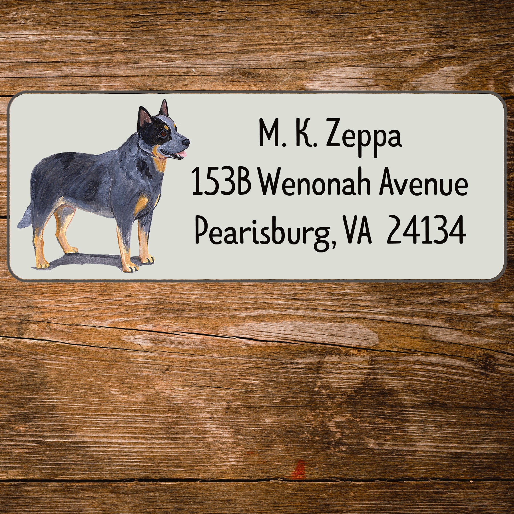 Return address label with an Australian Cattle Dog illustration on a wooden surface