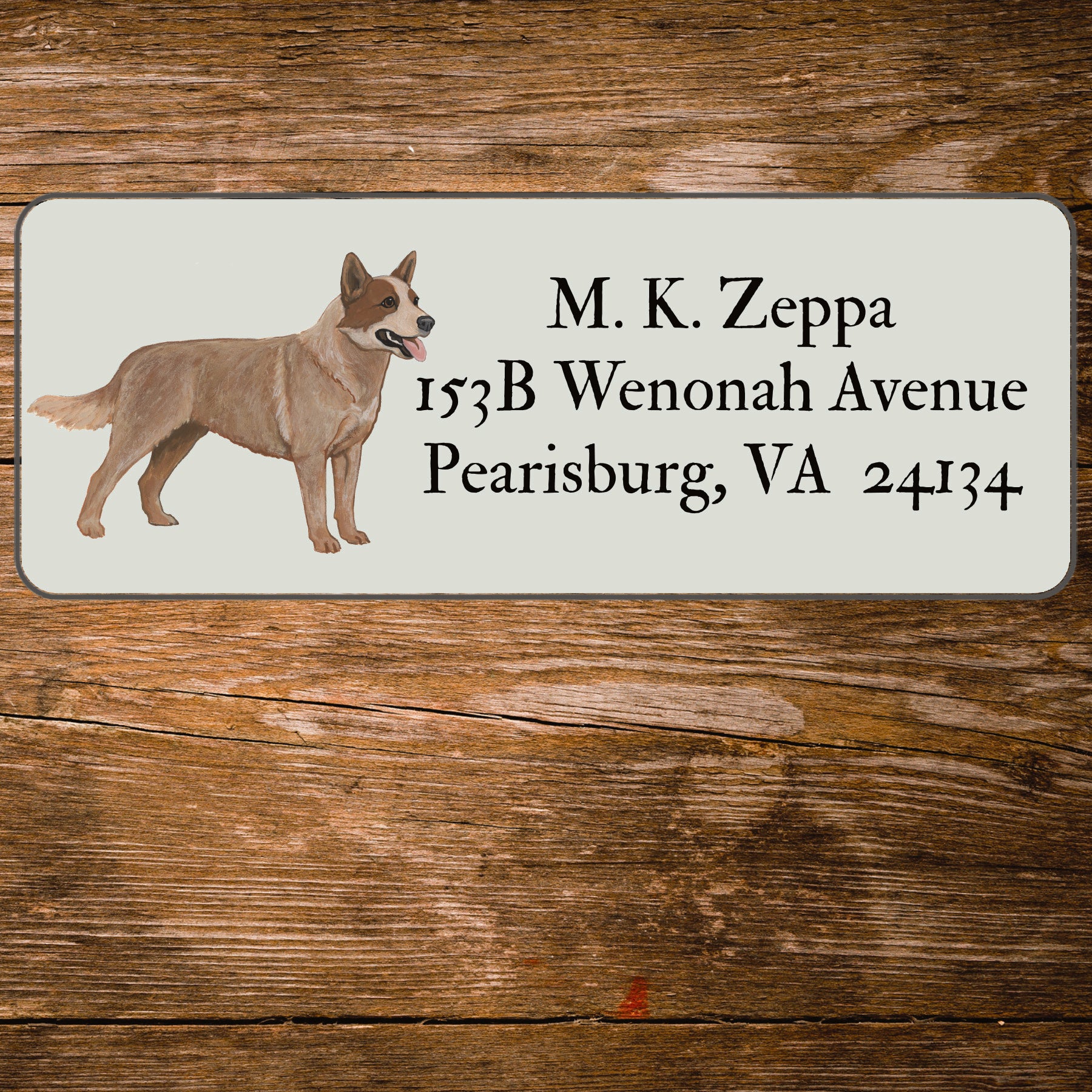 Return address label with an Australian Cattle Dog illustration on a wooden surface