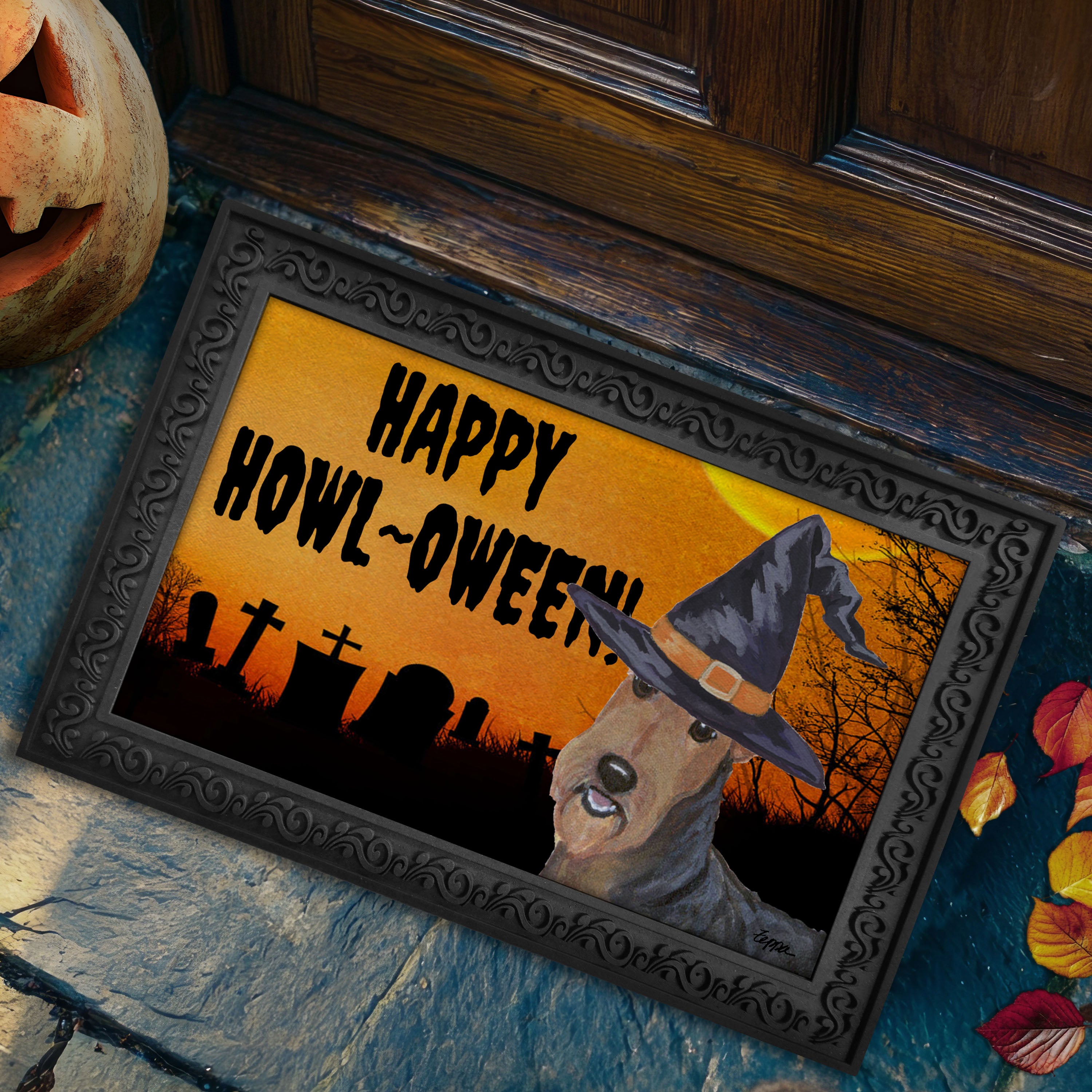 Halloween-themed doormat with a Airedale Terrier wearing a witch hat and 'Happy Howl-Oween!' text on a doorstep.
