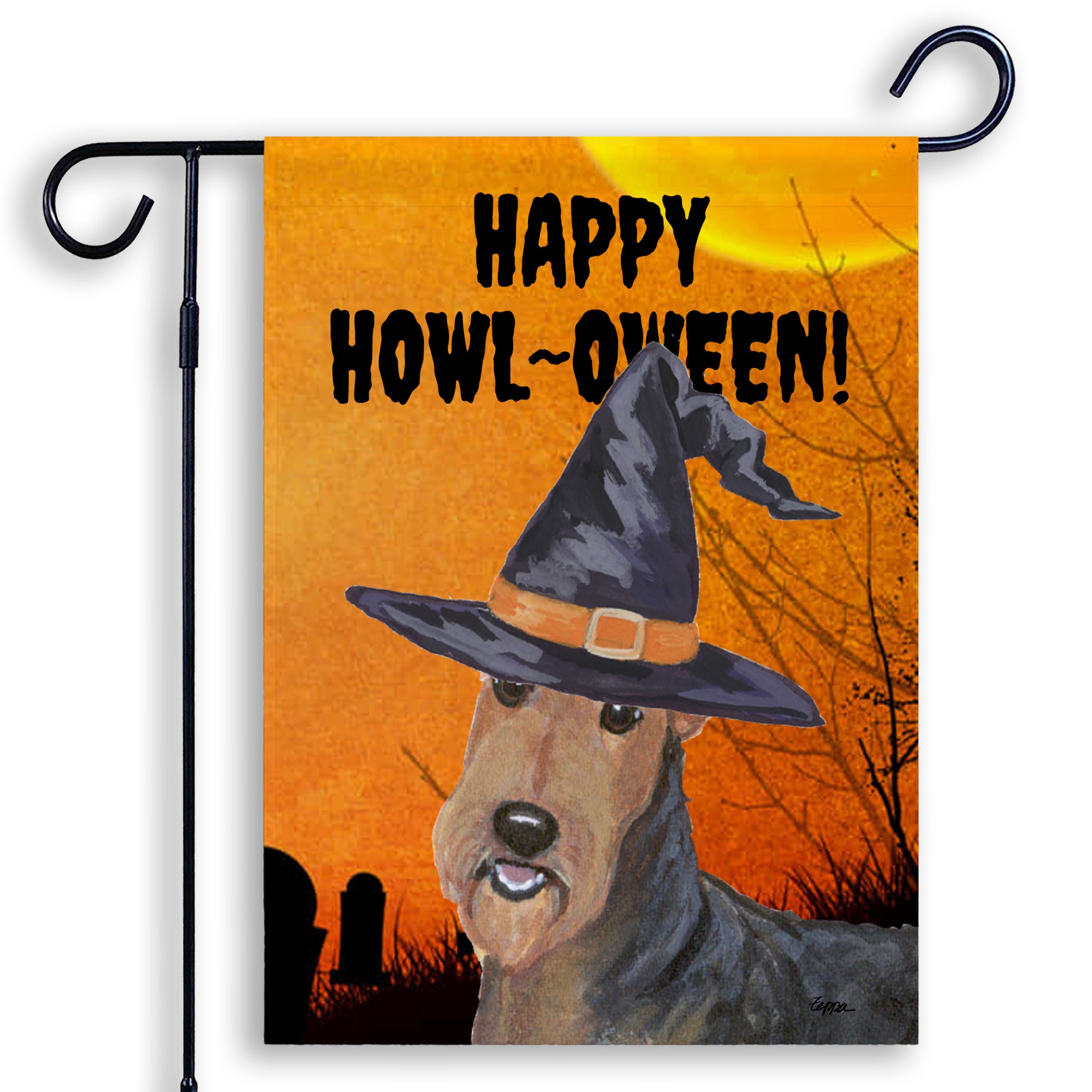 Halloween-themed garden flag with an Airedale wearing a witch hat and 'Happy Howl-Oween!' text on an orange background.