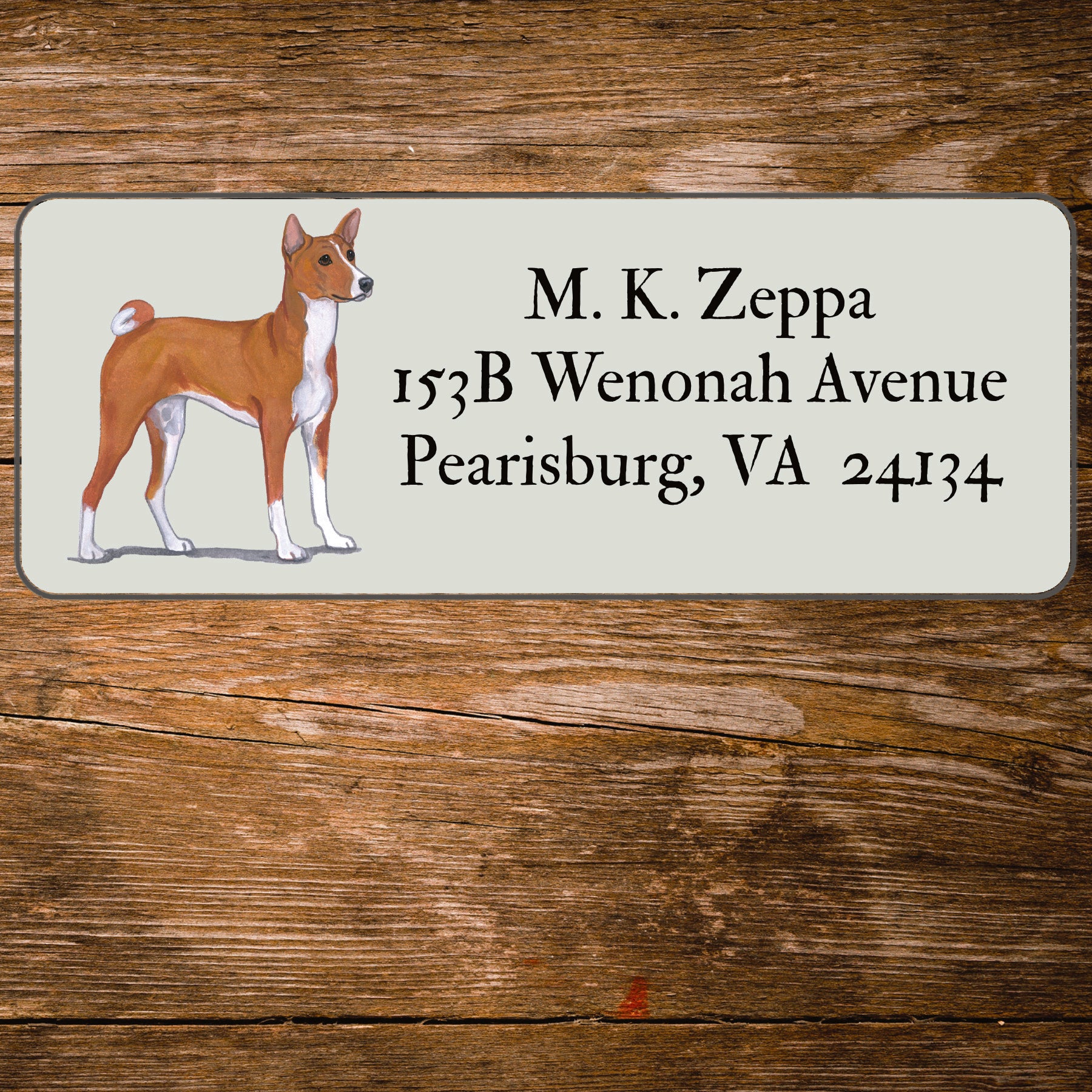 Address label with an Basenji illustration on a wooden background
