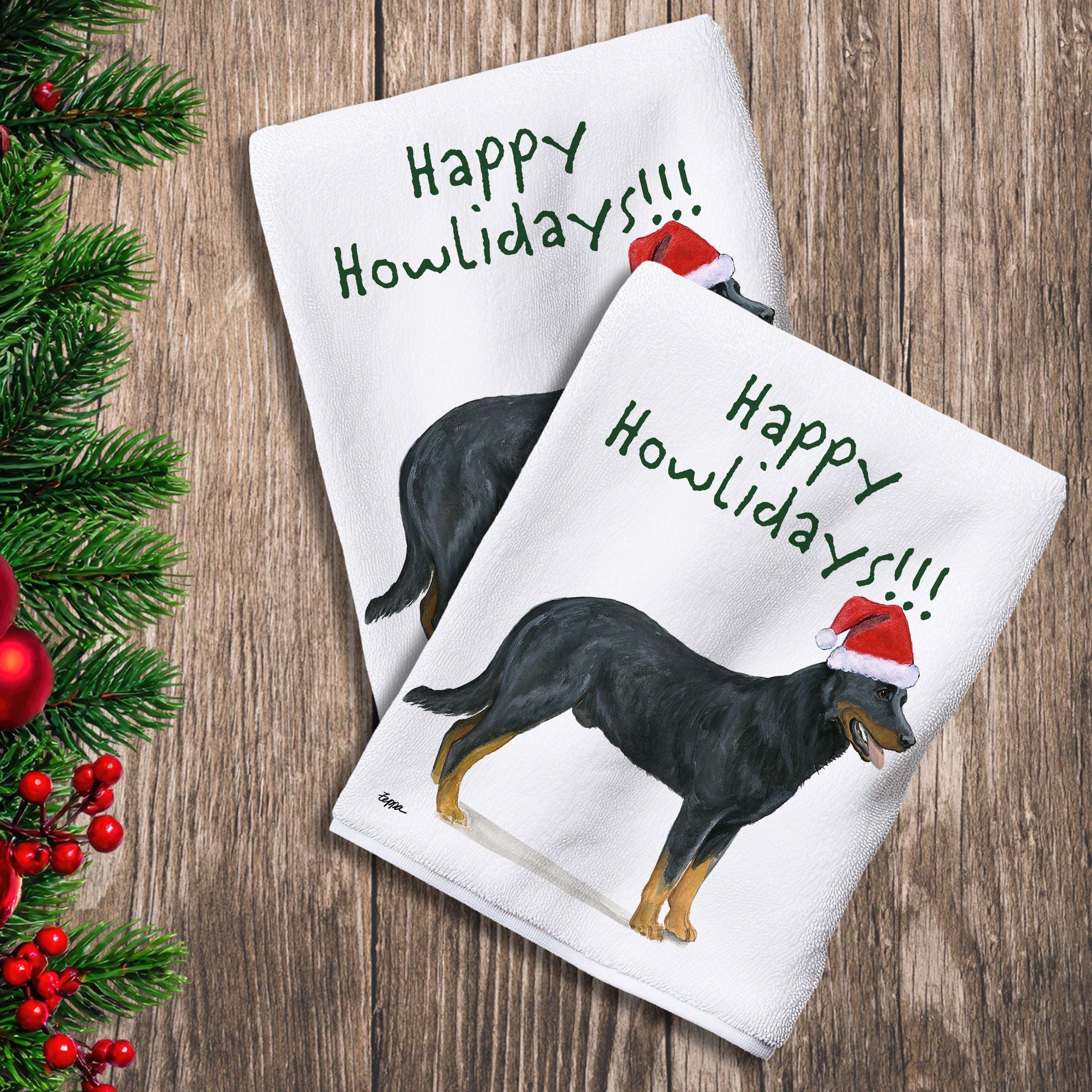 2 Kitchen Towels with a Beauceron in a Santa Hat and Happy Howlidays text.