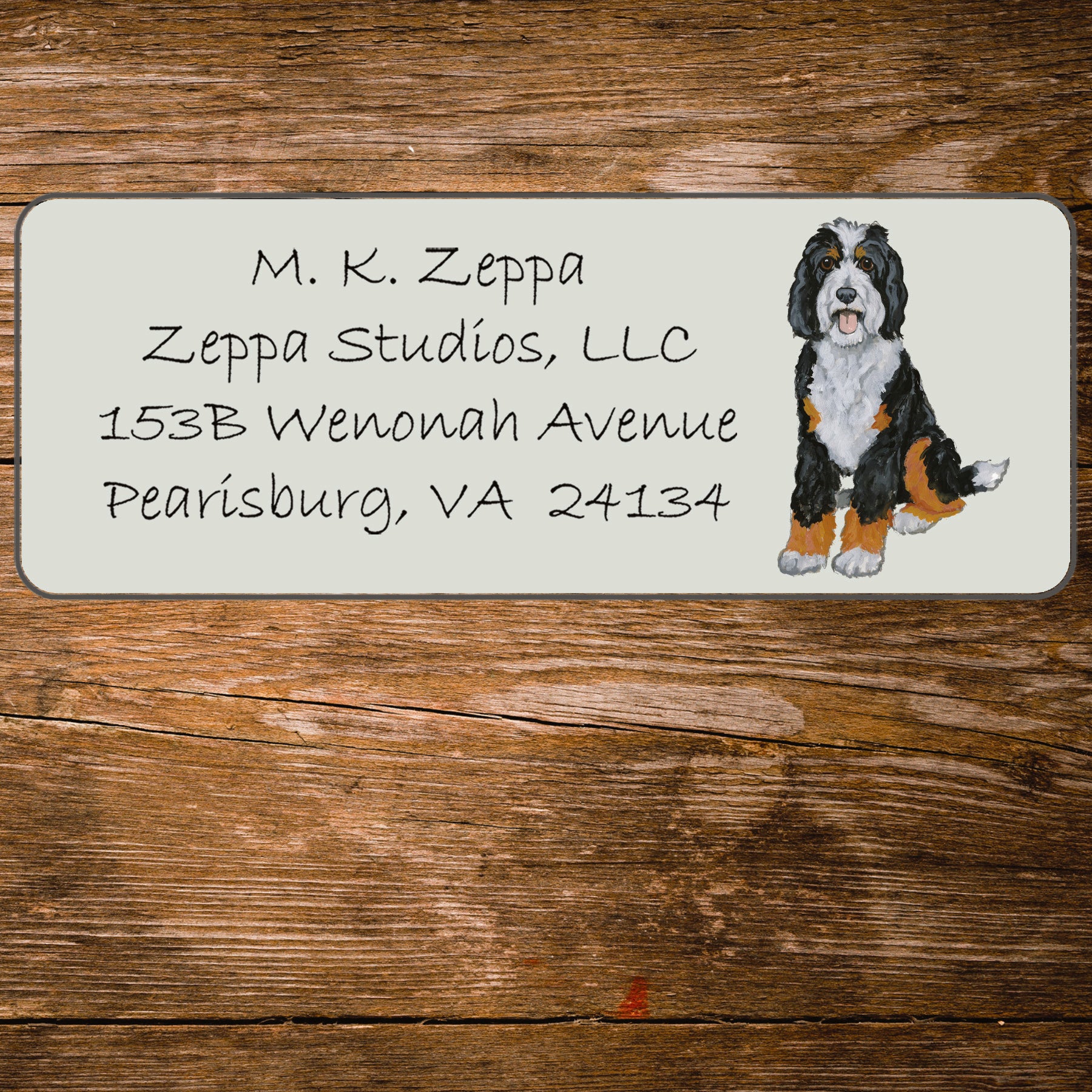 Return address label with an illustration of a Bernedoodle
