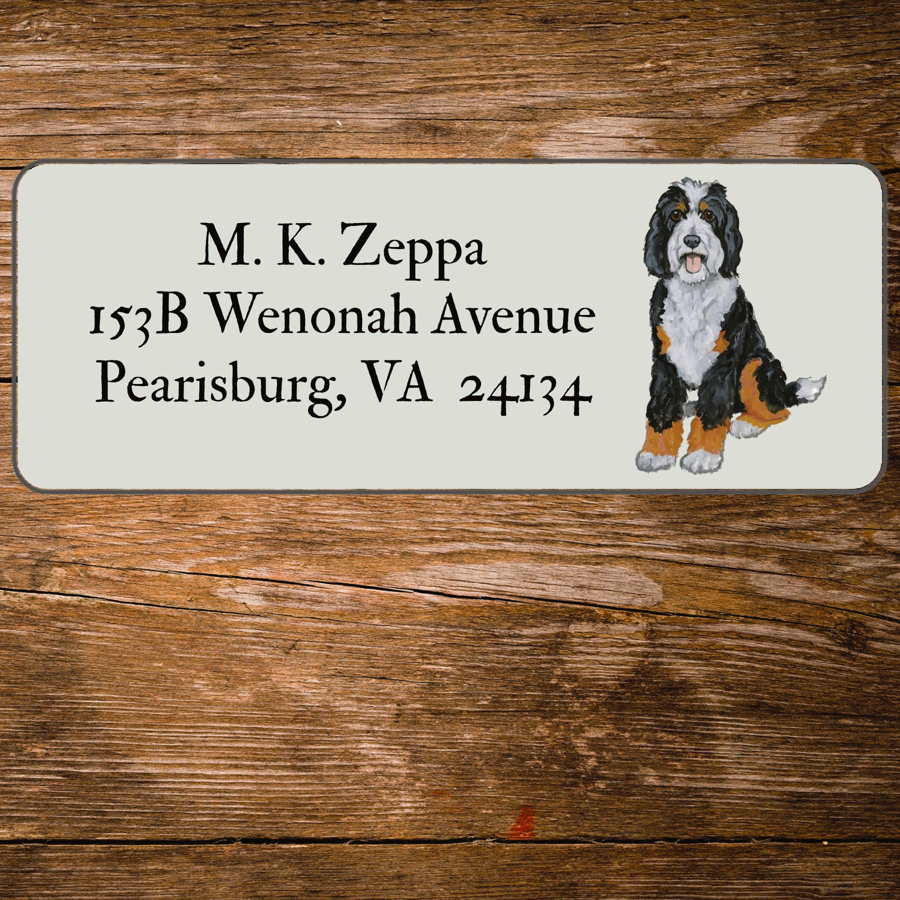 Return address label with an illustration of a Bernedoodle