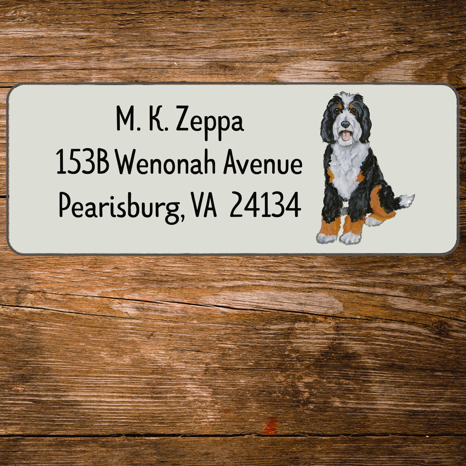 Return address label with an illustration of a Bernedoodle