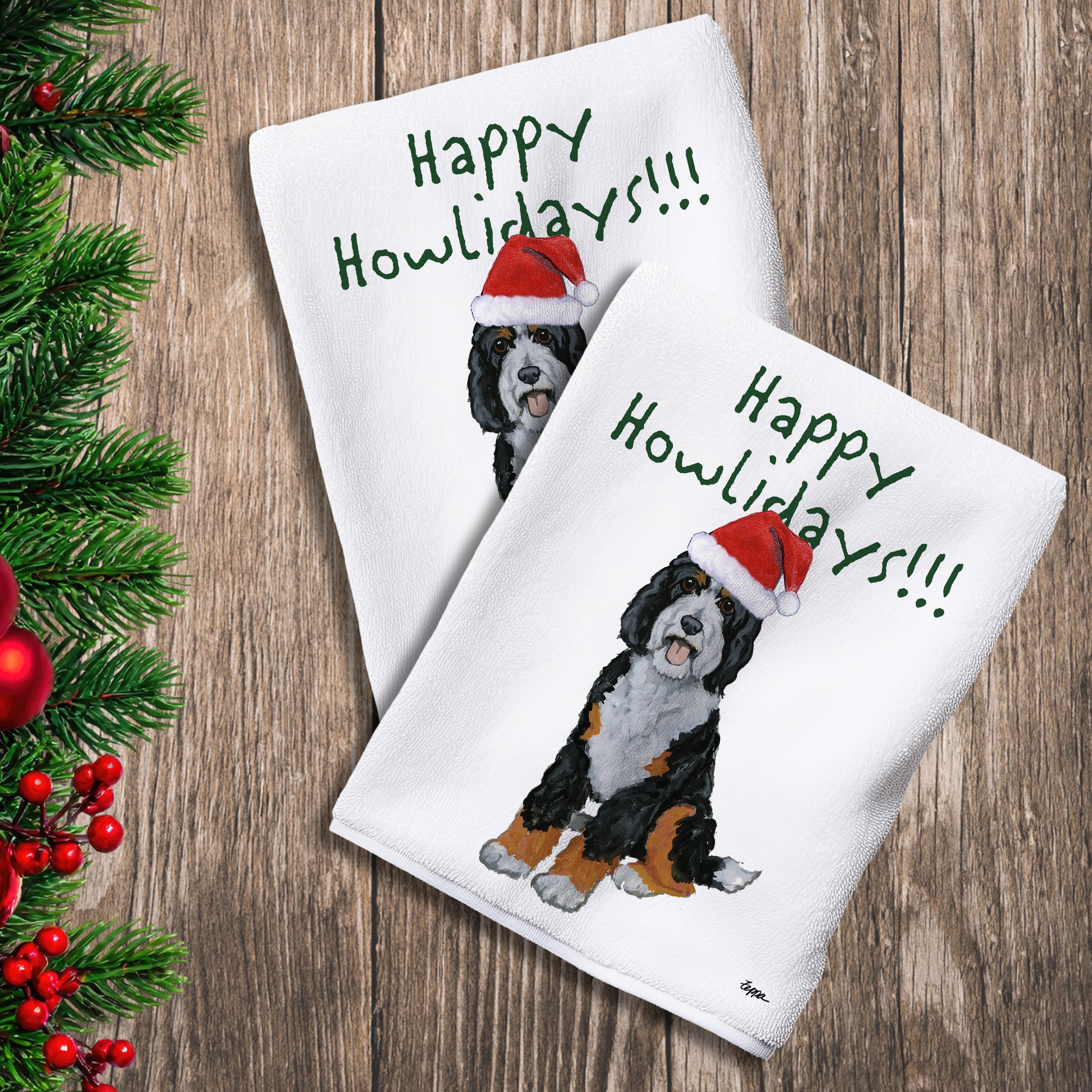 2 Kitchen Towels with a Bernedoodle in a Santa Hat and Happy Howlidays text.
