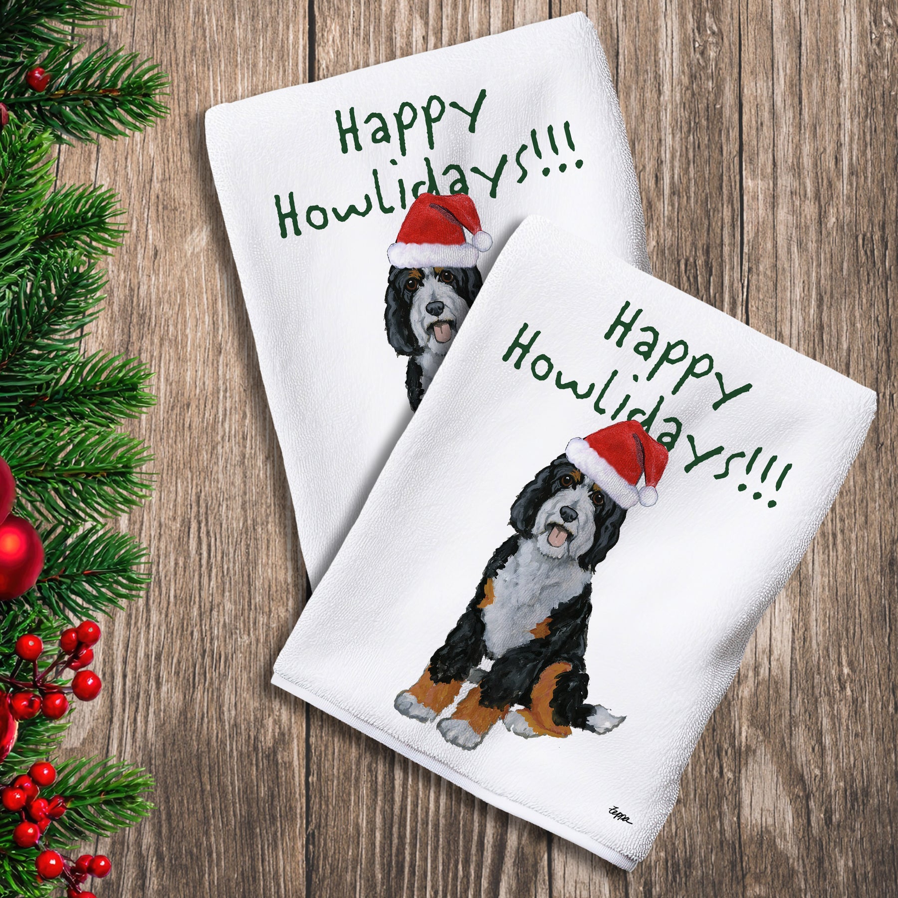 2 Kitchen Towels with a Bernedoodle in a Santa Hat and Happy Howlidays text.
