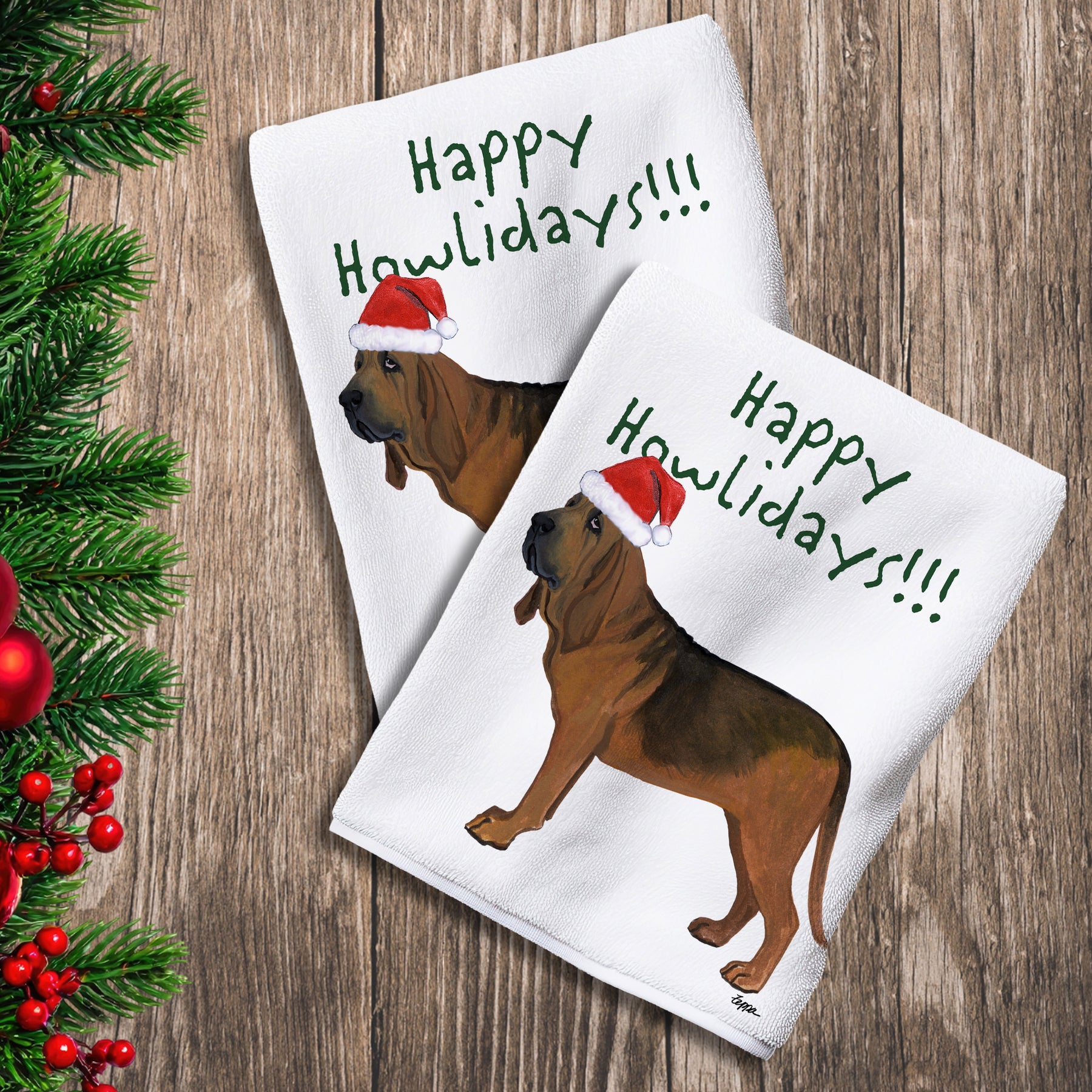 2 Kitchen Towels with a Bloodhound in a Santa Hat and Happy Howlidays text.