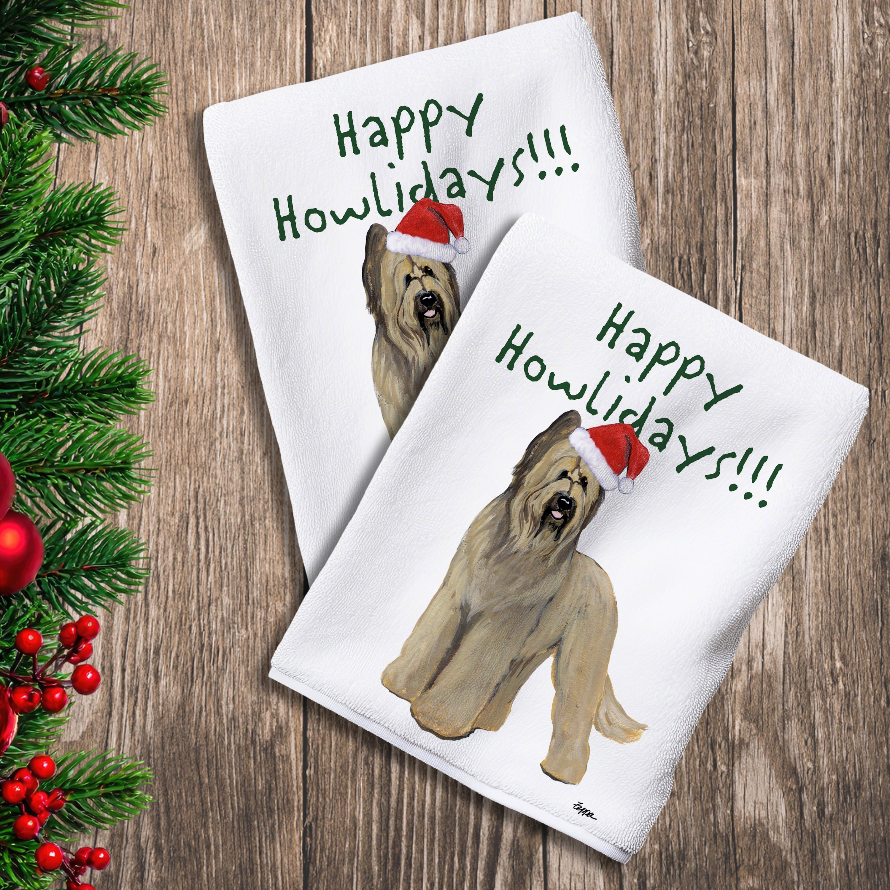 2 Kitchen Towels with a Briard in a Santa Hat and Happy Howlidays text.