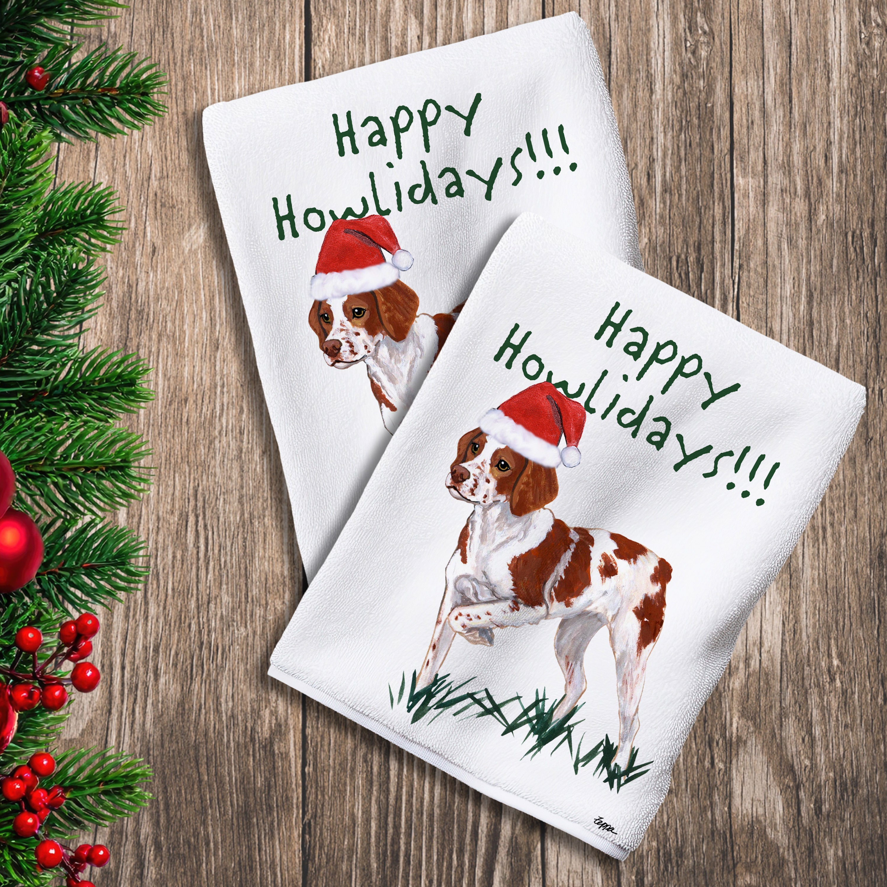 2 Kitchen Towels with a Brittany in a Santa Hat and Happy Howlidays text.