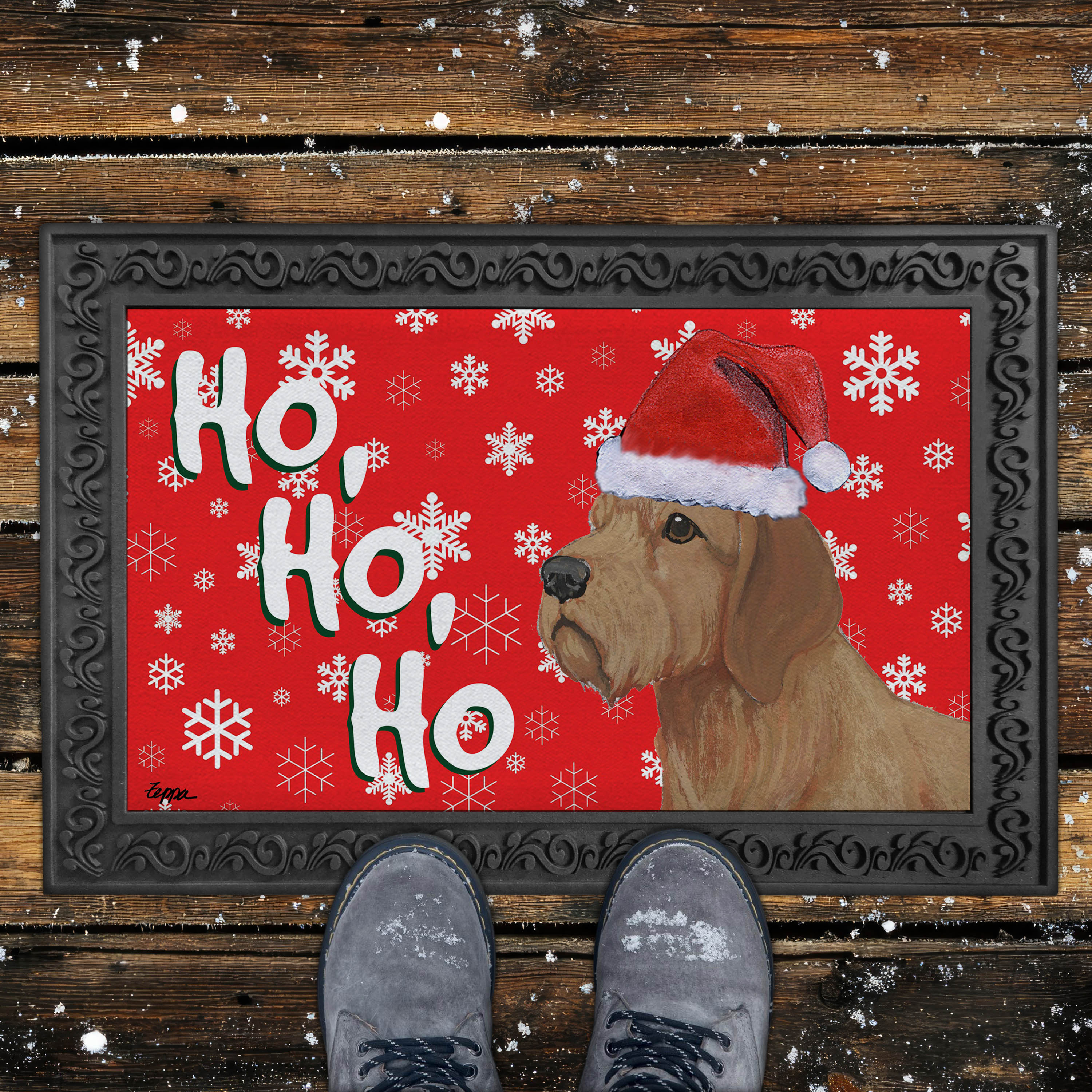 Holiday doormat with a Basset Fauve de Bretagne in a Santa hat on a red snowflake background