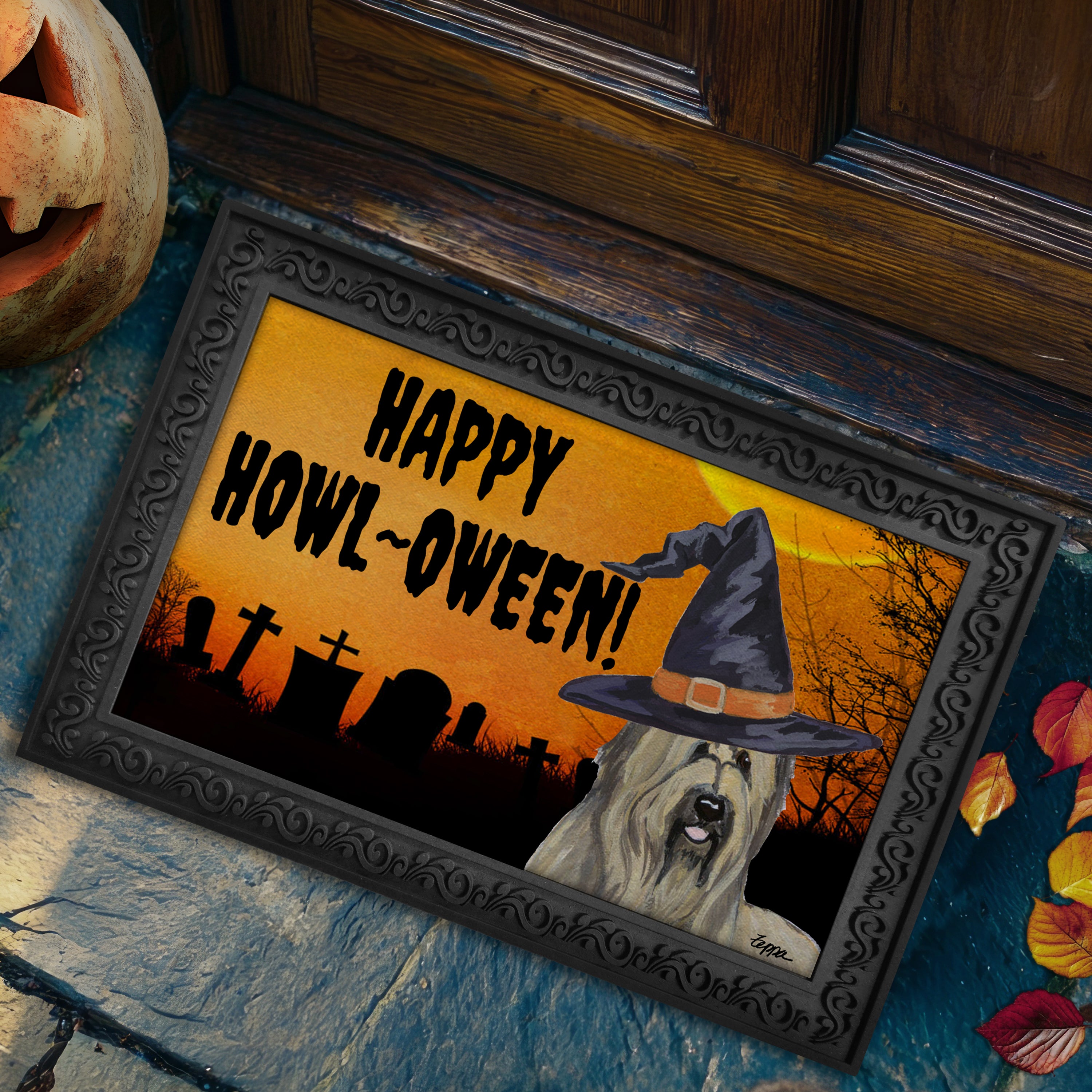 Halloween-themed doormat with a Briard wearing a witch hat and 'Happy Howl-Oween!' text on a doorstep.