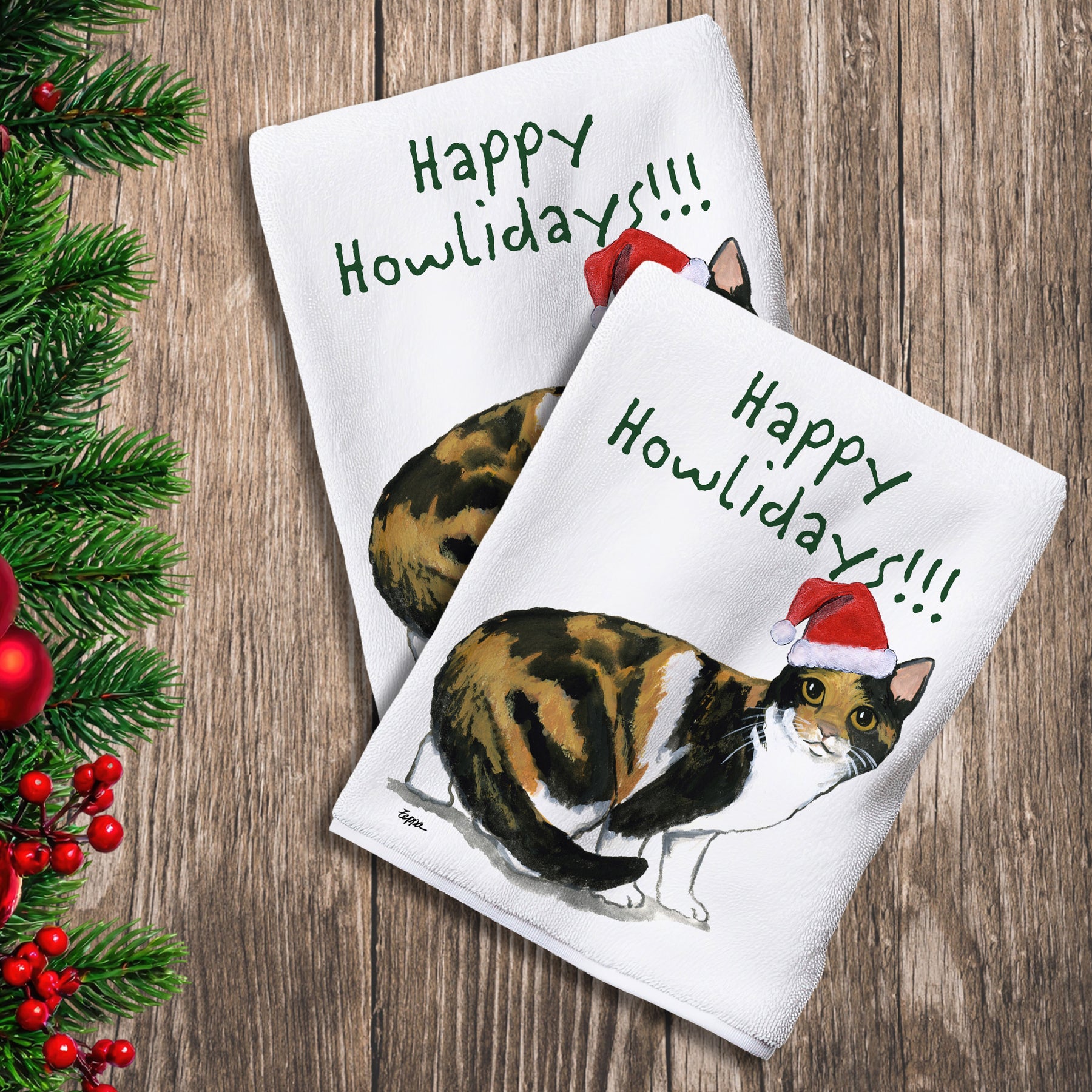2 Kitchen Towels with a Calico Cat in a Santa Hat and Happy Howlidays text.
