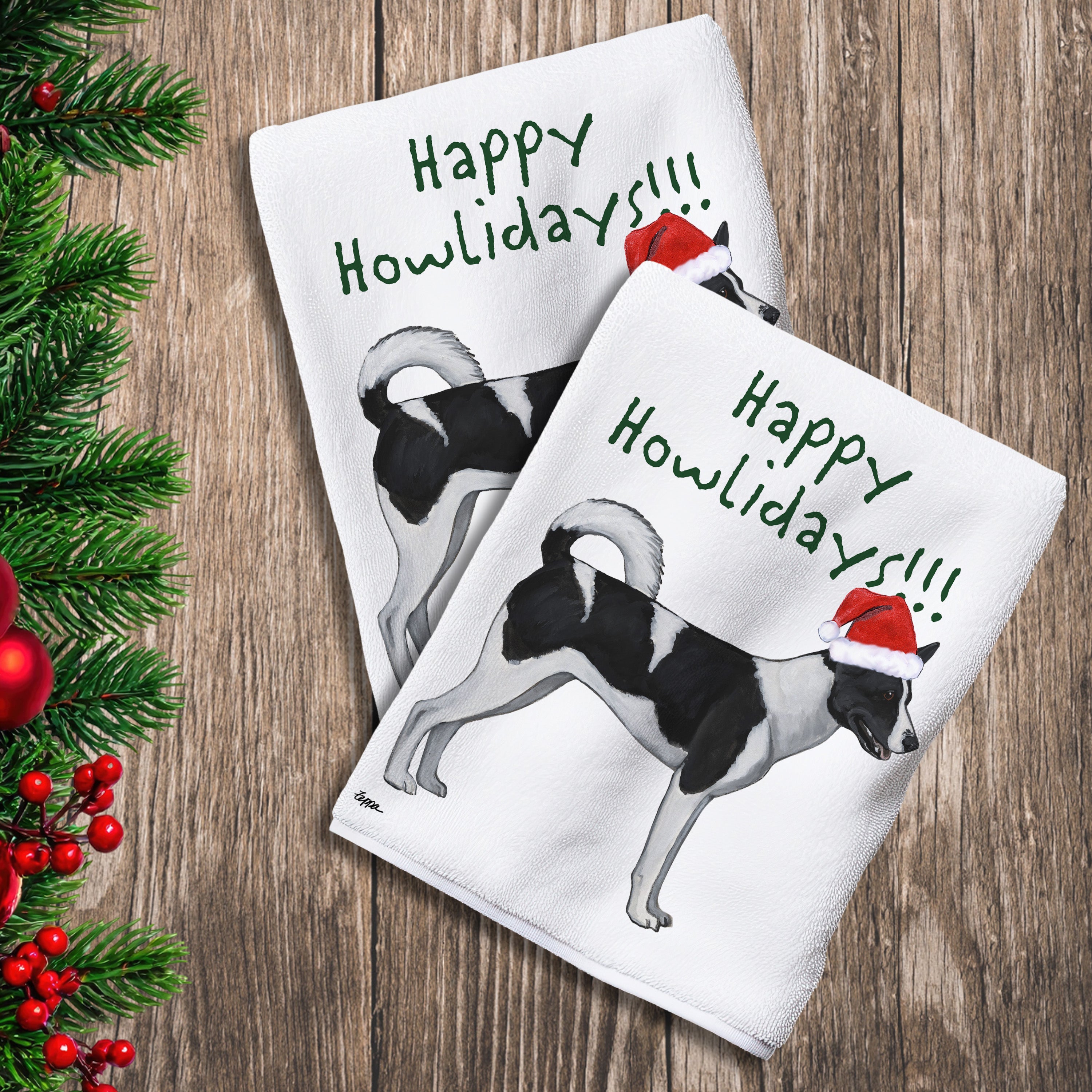 2 Kitchen Towels with a Canaan Dog in a Santa Hat and Happy Howlidays text.