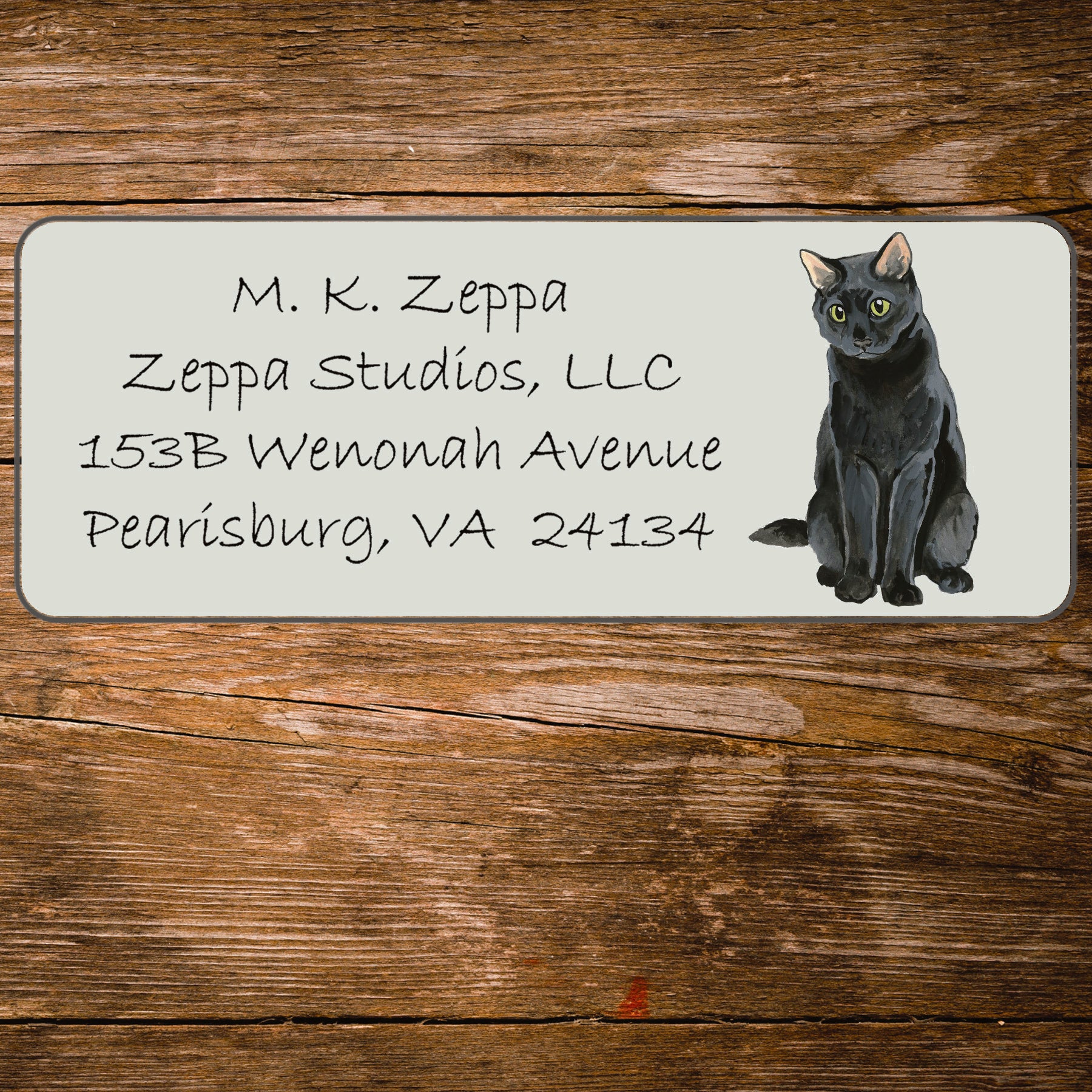 Return address label with an illustration of a Black Cat.
