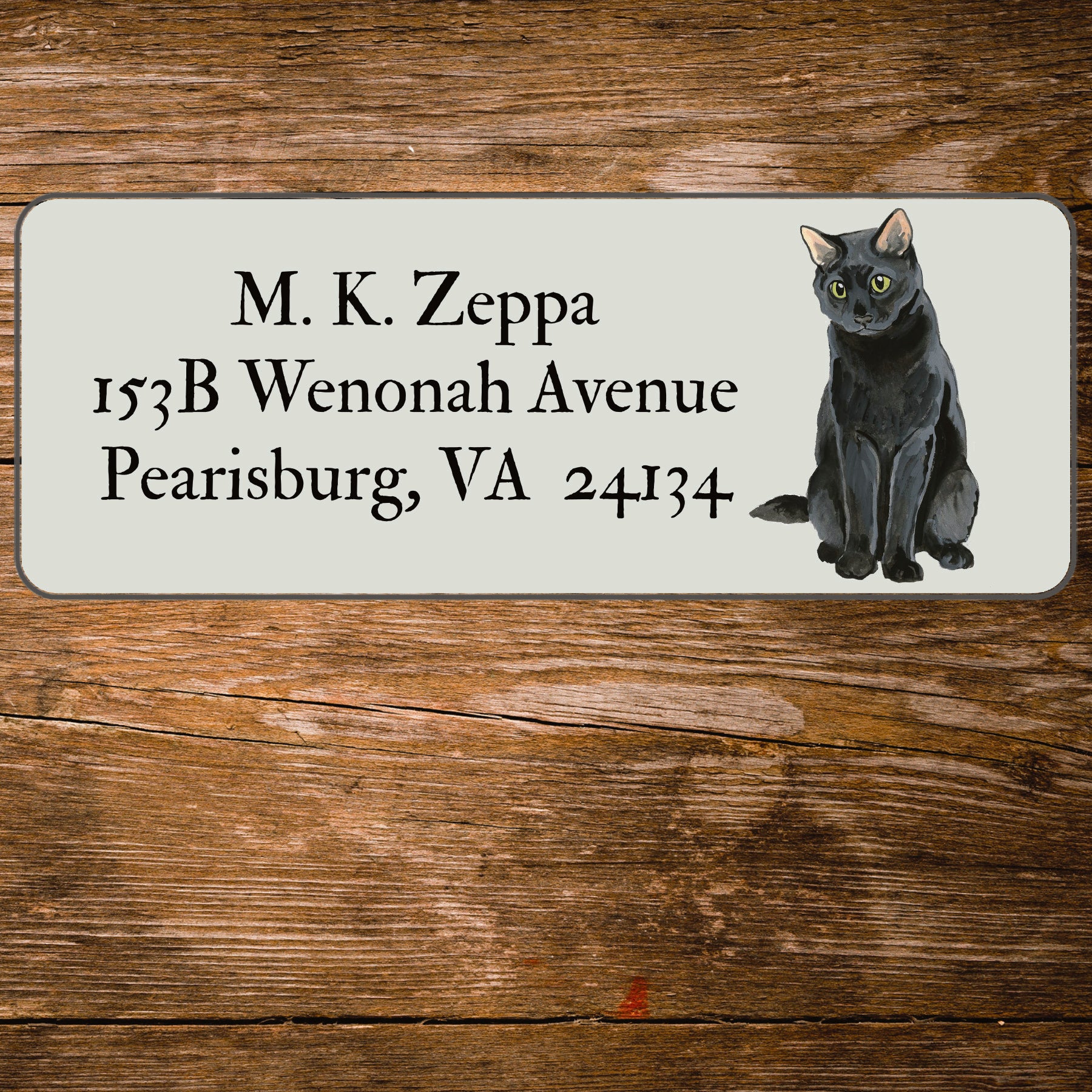 Return address label with an illustration of a Black Cat.