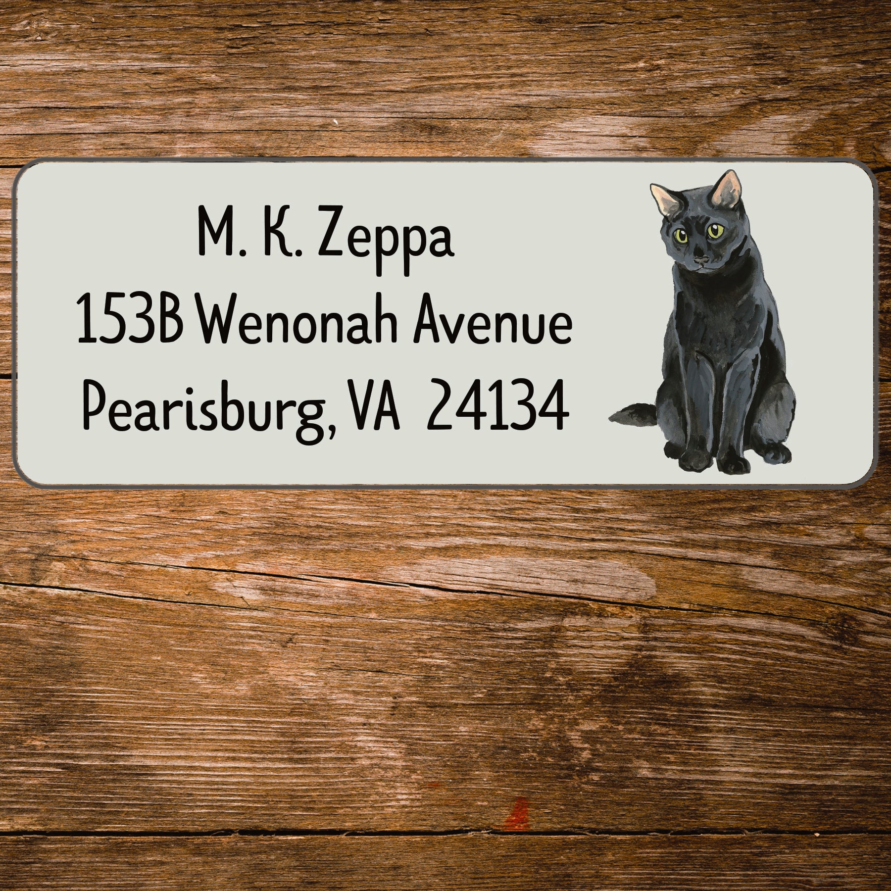 Return address label with an illustration of a Black Cat.