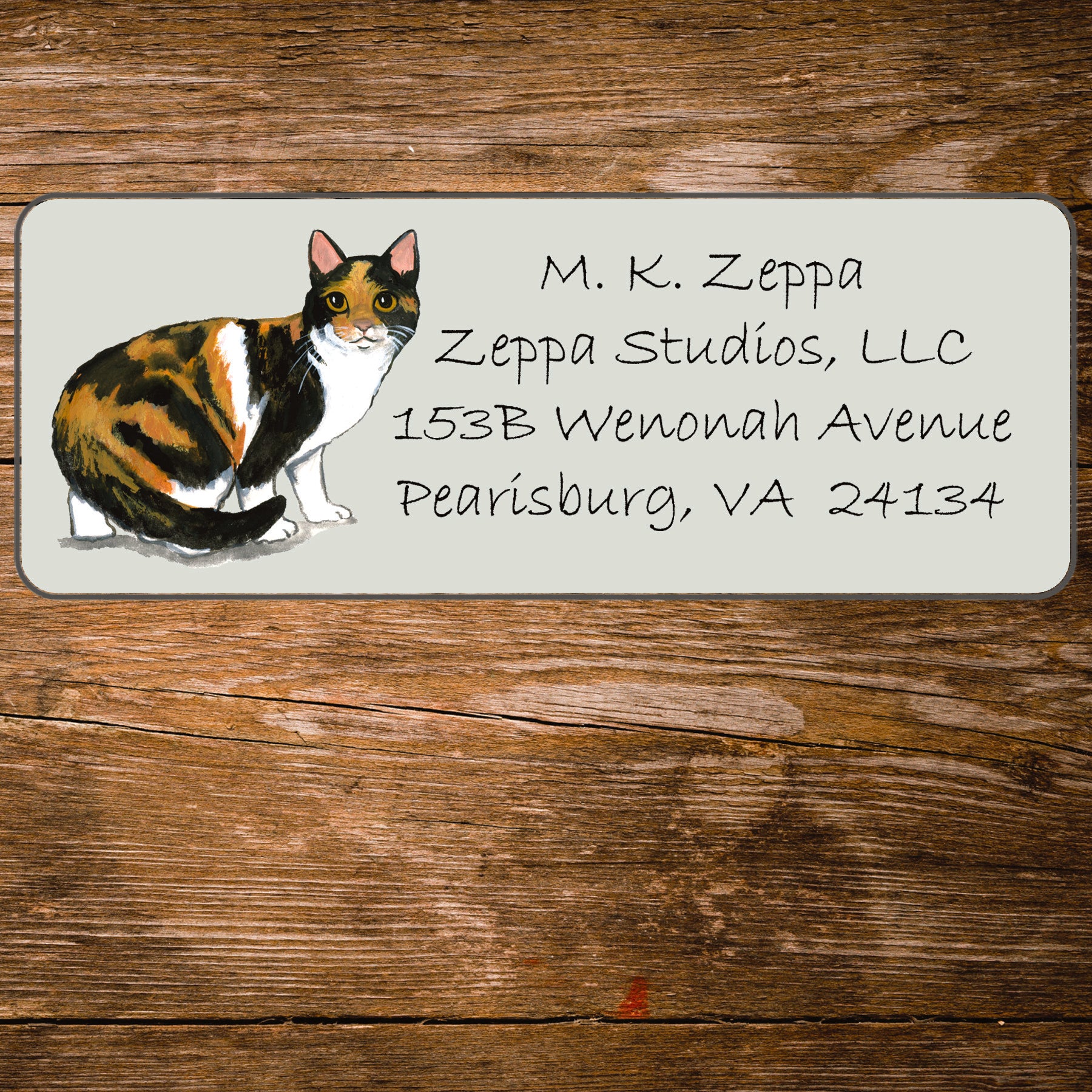 Return address label with a Calico Cat illustration.