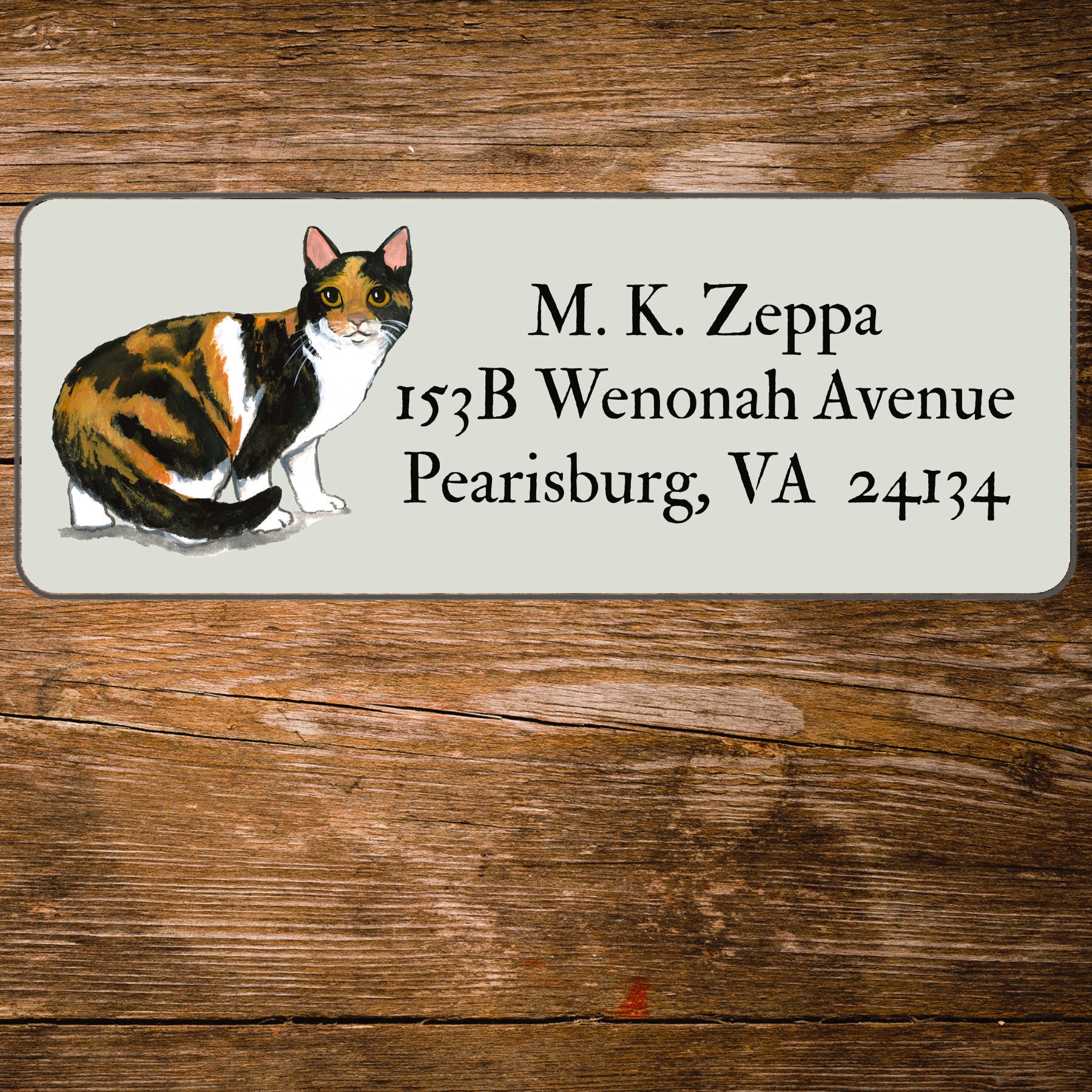 Return address label with a Calico Cat illustration.
