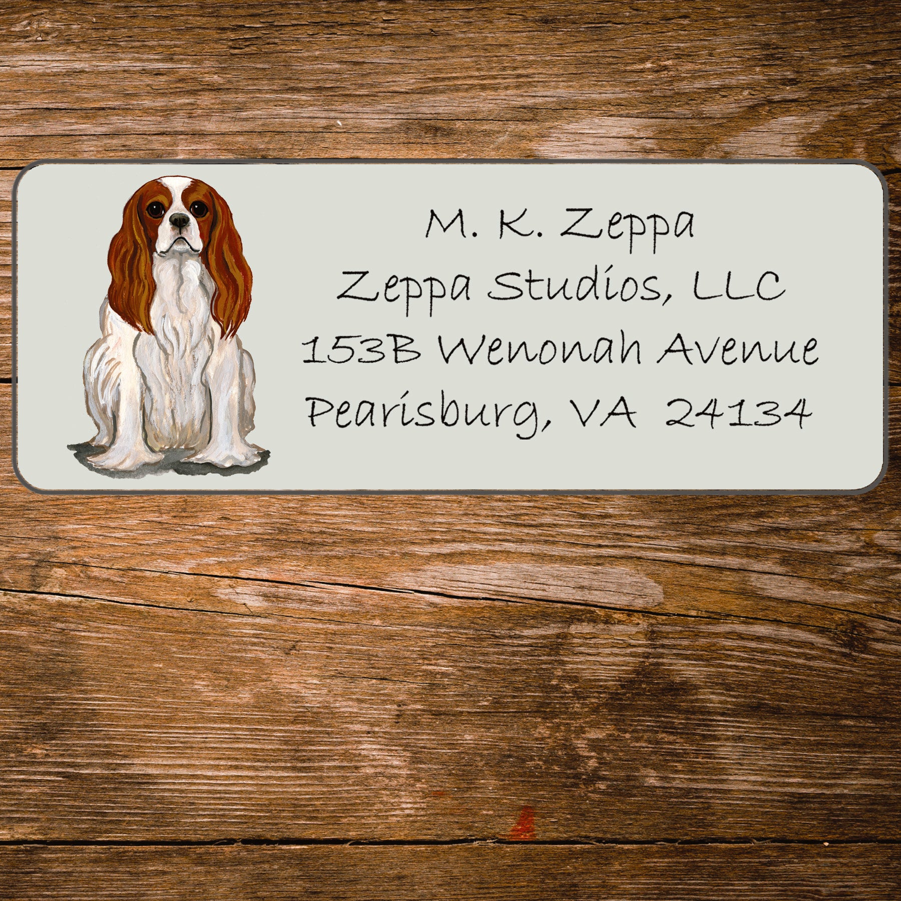 Return address label with a Cavalier King Charles Spaniel illustration.