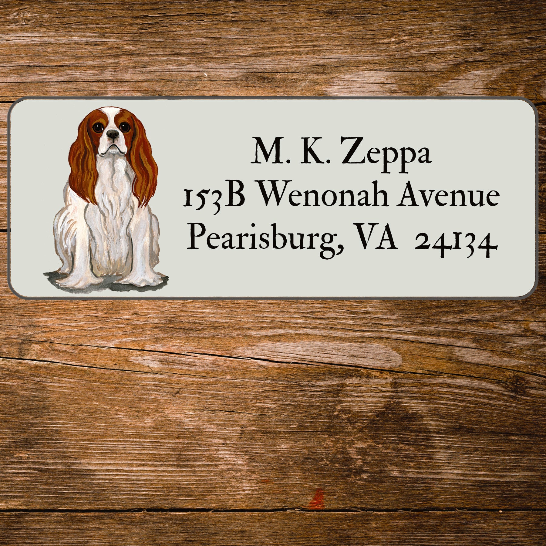 Return address label with a Cavalier King Charles Spaniel illustration.