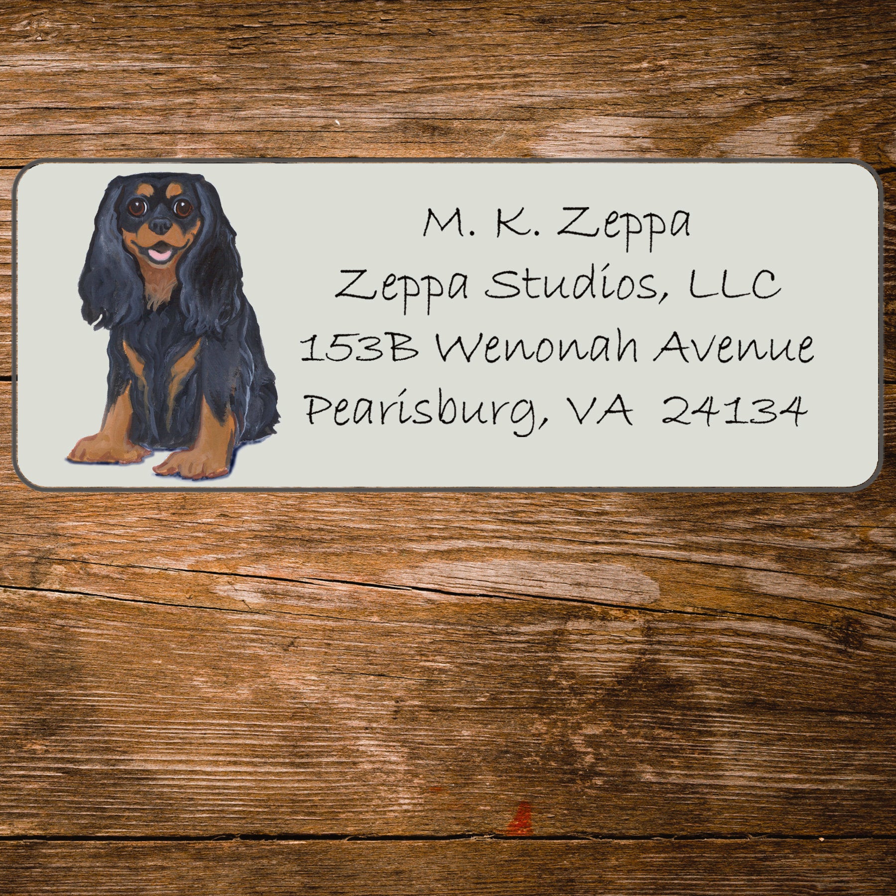 Return address label with a Cavalier King Charles Spaniel illustration.