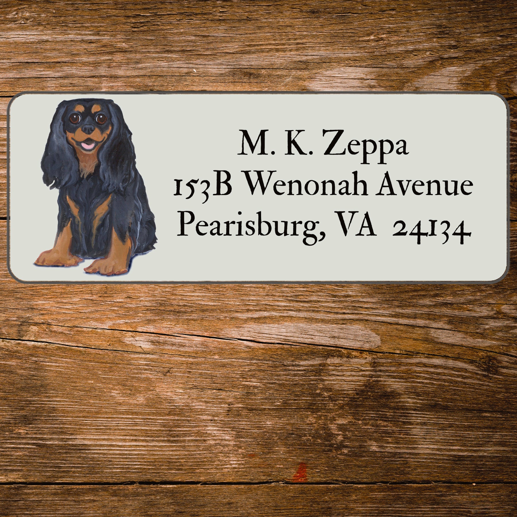 Return address label with a Cavalier King Charles Spaniel illustration.