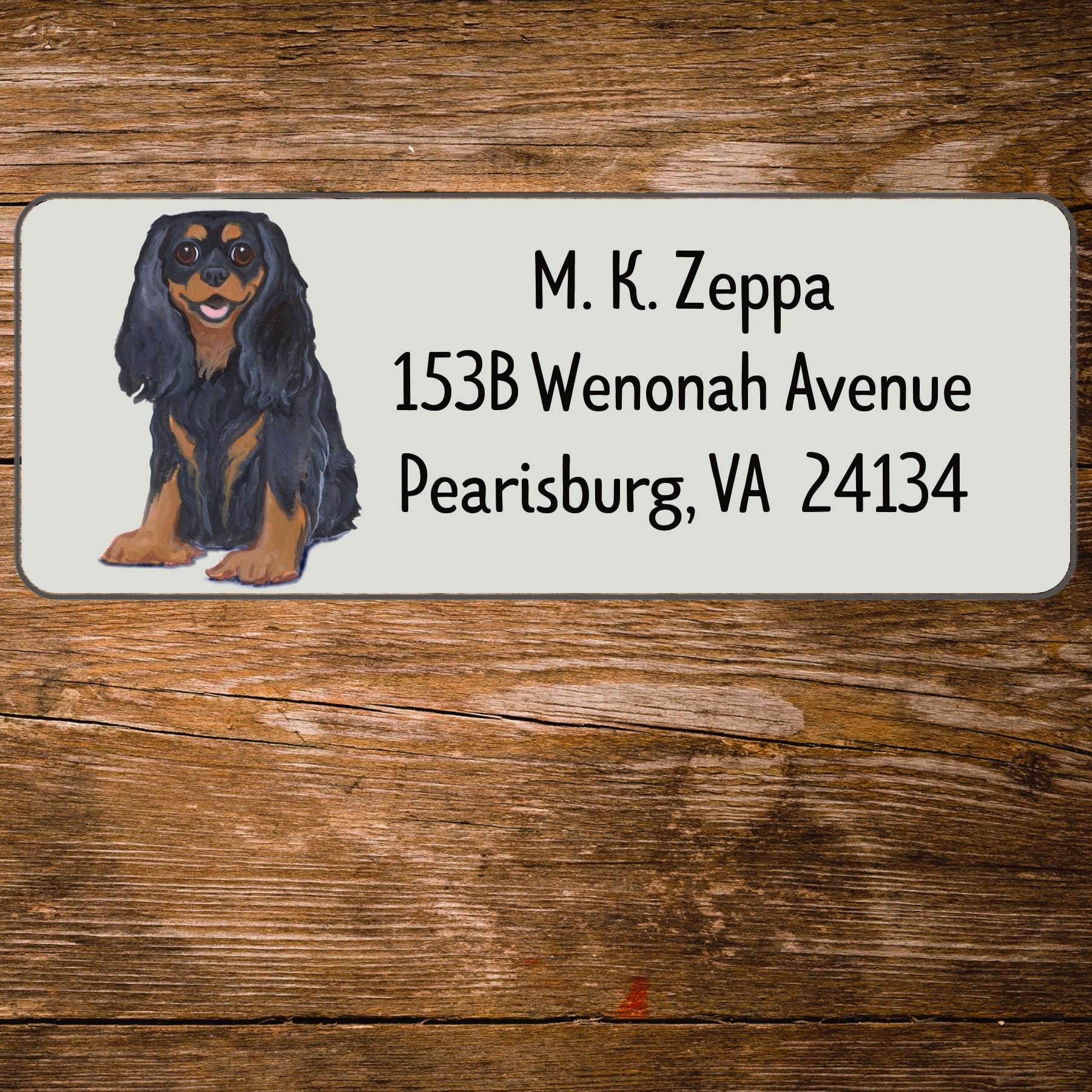 Return address label with a Cavalier King Charles Spaniel illustration.